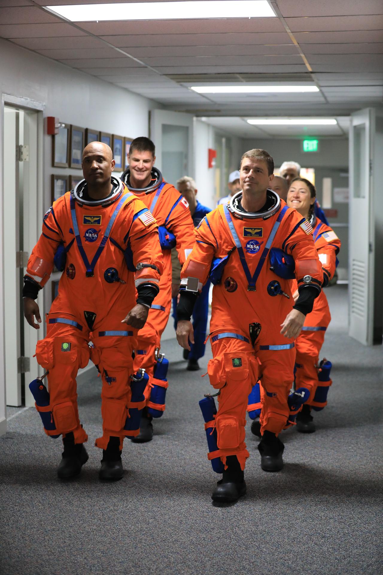 From left to right, Artemis II Pilot Victor Glover and Commander Reid Wiseman (front), Mission Specialist Jeremy Hansen from the CSA (Canadian Space Agency) and Mission Specialist Christina Koch, from NASA prepare to walk out of the Neil A. Armstrong Operations and Checkout Building at the agency’s Kennedy Space Center in Florida on Wednesday, April 1, 2026, ahead of the Artemis II test flight. The mission will take the Artemis II crew on a 10-day journey around the Moon and back aboard NASA’s SLS (Space Launch System) rocket and Orion spacecraft with a two hour launch window opening at 6:24 p.m. EDT from Launch Complex 39B at NASA Kennedy. 
