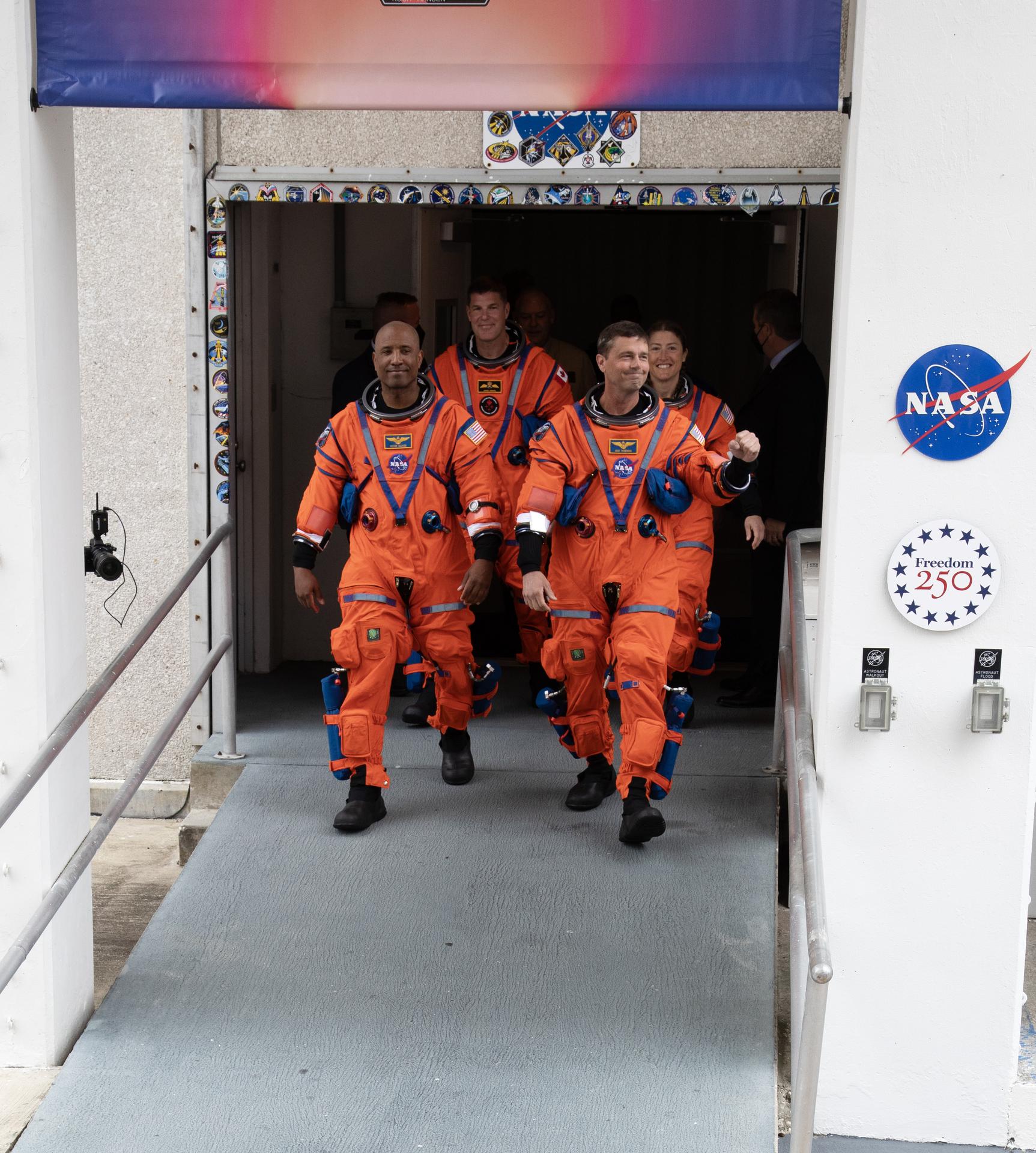 From left to right, NASA astronauts Artemis II Pilot Victor Glover and Commander Reid Wiseman (front), Mission Specialist Jeremy Hansen from the CSA (Canadian Space Agency), and Mission Specialist Christina Koch, from NASA walk out of the Neil A. Armstrong Operations and Checkout Building at the agency’s Kennedy Space Center in Florida on Wednesday, April 1, 2026, ahead of the Artemis II test flight. The mission will take the Artemis II crew on a 10-day journey around the Moon and back aboard NASA’s SLS (Space Launch System) rocket and Orion spacecraft with a two hour launch window opening at 6:24 p.m. EDT from Launch Complex 39B at NASA Kennedy. 