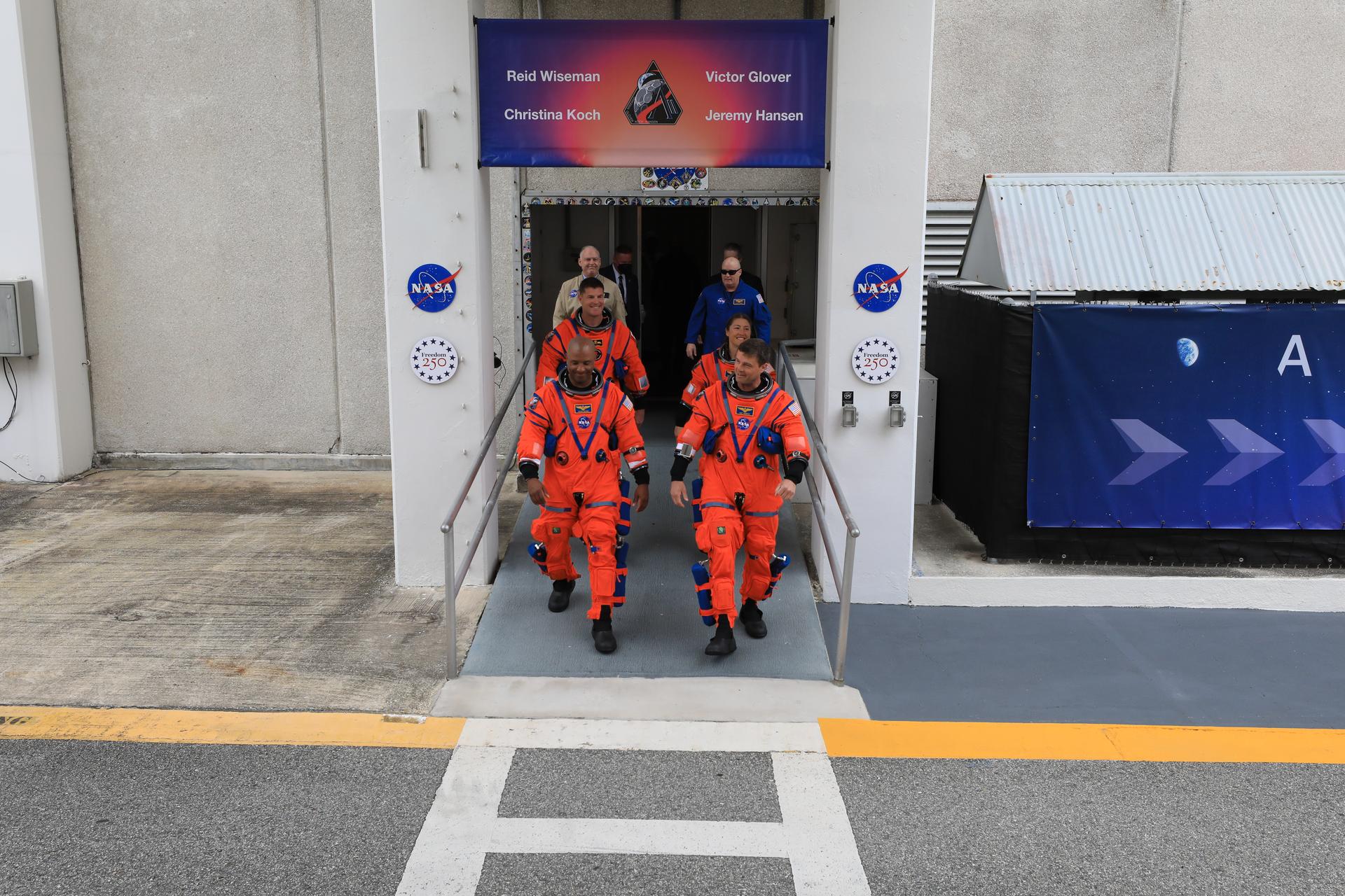 From left to right, NASA astronauts Artemis II Pilot Victor Glover and Commander Reid Wiseman (front), Mission Specialist Jeremy Hansen from the CSA (Canadian Space Agency), and Mission Specialist Christina Koch, from NASA walk out of the Neil A. Armstrong Operations and Checkout Building at the agency’s Kennedy Space Center in Florida on Wednesday, April 1, 2026, ahead of the Artemis II test flight. The mission will take the Artemis II crew on a 10-day journey around the Moon and back aboard NASA’s SLS (Space Launch System) rocket and Orion spacecraft with a two hour launch window opening at 6:24 p.m. EDT from Launch Complex 39B at NASA Kennedy. 