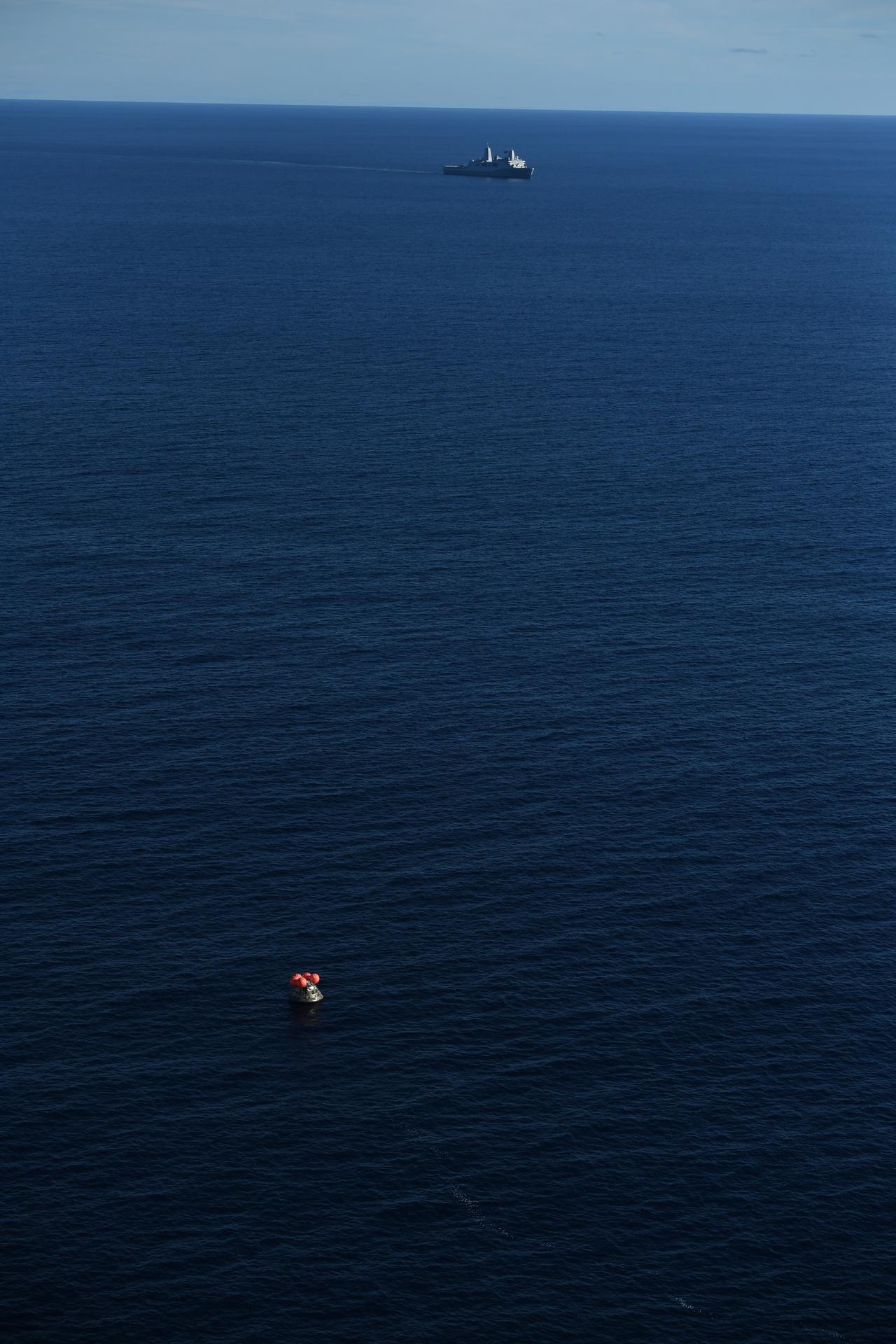 USS John P. Murtha approaches NASA's Orion spacecraft carrying Artemis II Commander Reid Wiseman, Pilot Victor Glover, and Mission Specialist...