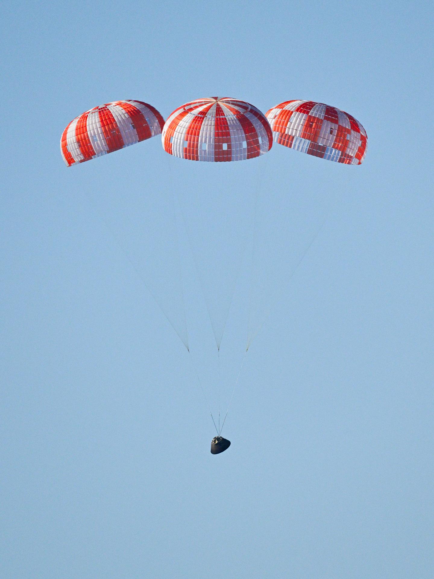 Parachutes secured to NASA’s Orion spacecraft deploy before splashdown in the Pacific Ocean near San Diego, California, on Friday, April 10, 2026, for the Artemis II test flight. The Artemis II mission carrying Artemis II Commander Reid Wiseman, Pilot Victor Glover, and Mission Specialist Christina Koch from NASA, along with Mission Specialist Jeremy Hansen from the CSA (Canadian Space Agency), launched on Wednesday, April 1, from NASA’s Kennedy Space Center in Florida to begin its 10-day journey around the Moon for scientific discovery, economic benefits, and to build on our foundation for the first crewed missions to Mars. NASA’s Landing and Recovery team and the U.S. military are coordinating efforts to extract the Artemis II crew from Orion.