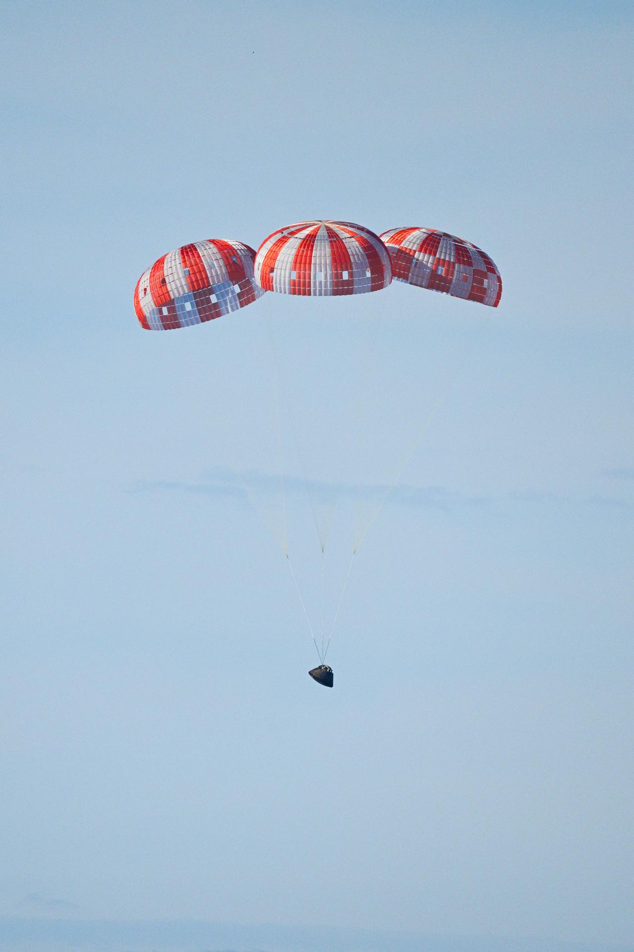 Parachutes secured to NASA’s Orion spacecraft deploy before splashdown in the Pacific Ocean near San Diego, California, on Friday, April 10, 2026, for the Artemis II test flight. The Artemis II mission carrying Artemis II Commander Reid Wiseman, Pilot Victor Glover, and Mission Specialist Christina Koch from NASA, along with Mission Specialist Jeremy Hansen from the CSA (Canadian Space Agency), launched on Wednesday, April 1, from NASA’s Kennedy Space Center in Florida to begin its 10-day journey around the Moon for scientific discovery, economic benefits, and to build on our foundation for the first crewed missions to Mars. NASA’s Landing and Recovery team and the U.S. military are coordinating efforts to extract the Artemis II crew from Orion.