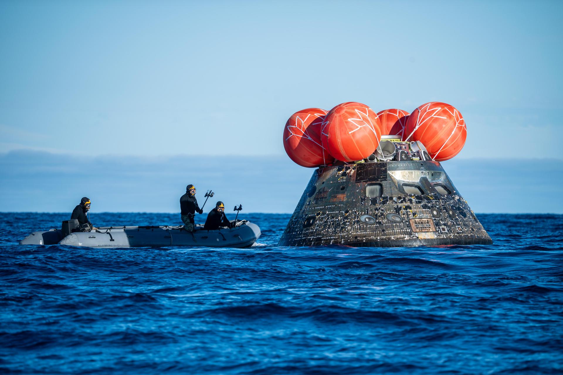 NASA’s Landing and Recovery team, along with U.S. Navy personnel aboard an inflatable raft approach NASA’s Orion spacecraft carrying Artemis II Commander Reid Wiseman, Pilot Victor Glover, and Mission Specialist Christina Koch from NASA, along with Mission Specialist Jeremy Hansen from the CSA (Canadian Space Agency), following splashdown in the Pacific Ocean near San Diego, California, at 5:07 p.m. PDT, (8:07 p.m. EDT) on Friday, April 10, 2026. The Artemis II test flight launched on Wednesday, April 1, from NASA’s Kennedy Space Center in Florida to begin its 10-day journey around the Moon for scientific discovery, economic benefits, and to build on our foundation for the first crewed missions to Mars. NASA’s Landing and Recovery team and the U.S. military are helping the Artemis II crew out of their Orion spacecraft. 