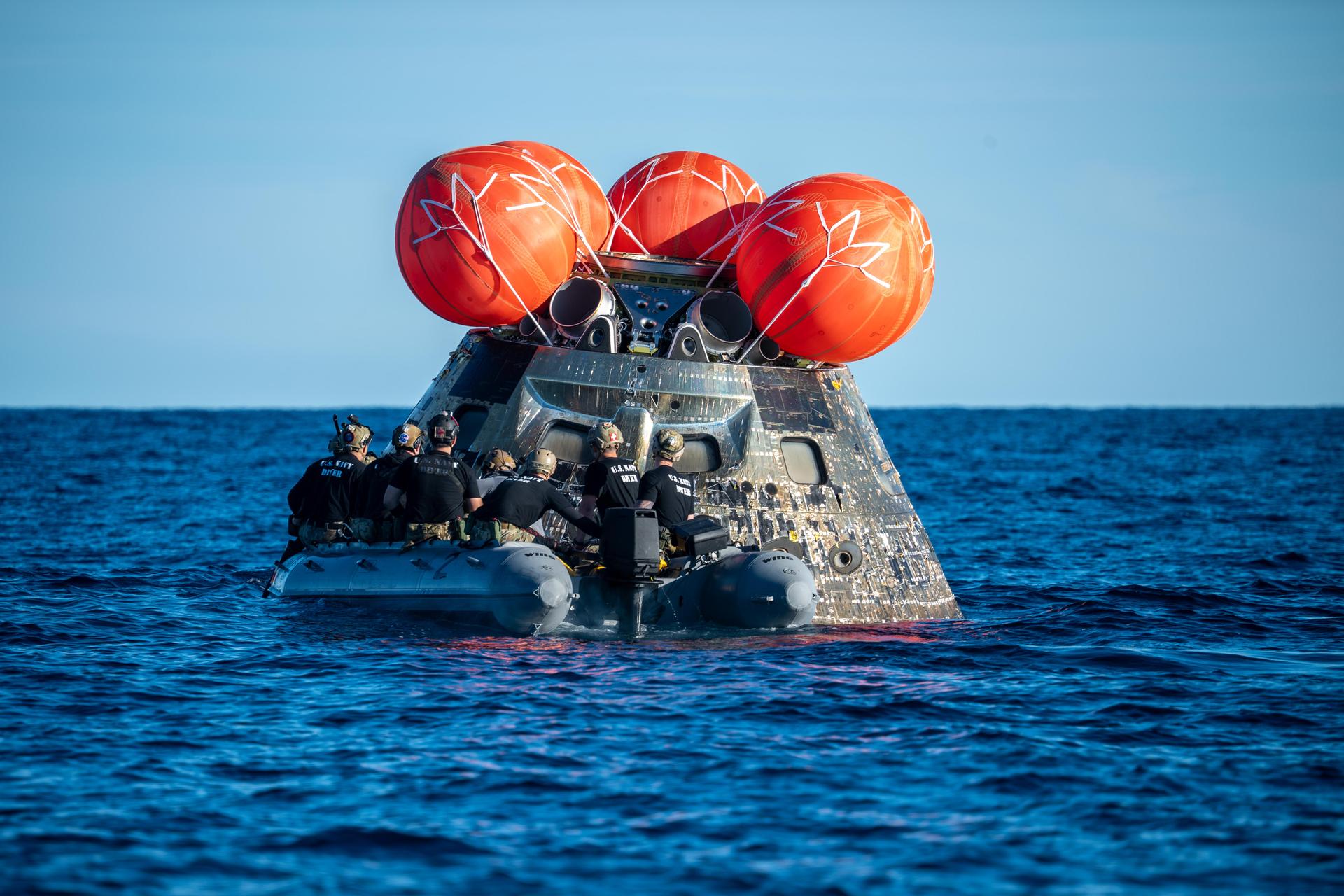 NASA’s Landing and Recovery team, along with U.S. Navy personnel aboard an inflatable raft approach NASA’s Orion spacecraft carrying Artemis II Commander Reid Wiseman, Pilot Victor Glover, and Mission Specialist Christina Koch from NASA, along with Mission Specialist Jeremy Hansen from the CSA (Canadian Space Agency), following splashdown in the Pacific Ocean near San Diego, California, at 5:07 p.m. PDT, (8:07 p.m. EDT) on Friday, April 10, 2026. The Artemis II test flight launched on Wednesday, April 1, from NASA’s Kennedy Space Center in Florida to begin its 10-day journey around the Moon for scientific discovery, economic benefits, and to build on our foundation for the first crewed missions to Mars. NASA’s Landing and Recovery team and the U.S. military are helping the Artemis II crew out of their Orion spacecraft. 