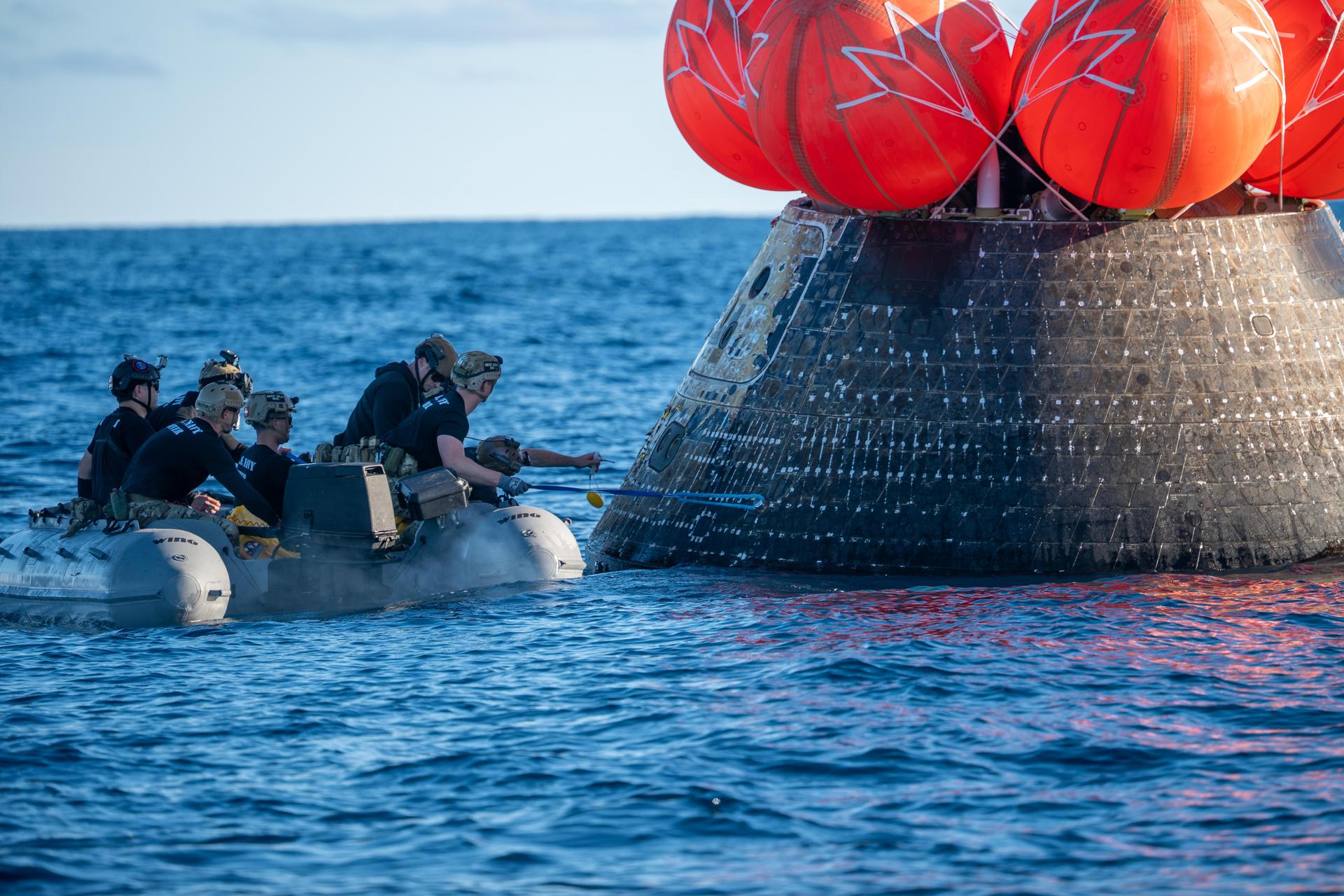 NASA’s Landing and Recovery team, along with U.S. Navy personnel aboard an inflatable raft approach NASA’s Orion spacecraft carrying Artemis II Commander Reid Wiseman, Pilot Victor Glover, and Mission Specialist Christina Koch from NASA, along with Mission Specialist Jeremy Hansen from the CSA (Canadian Space Agency), following splashdown in the Pacific Ocean near San Diego, California, at 5:07 p.m. PDT, (8:07 p.m. EDT) on Friday, April 10, 2026. The Artemis II test flight launched on Wednesday, April 1, from NASA’s Kennedy Space Center in Florida to begin its 10-day journey around the Moon for scientific discovery, economic benefits, and to build on our foundation for the first crewed missions to Mars. NASA’s Landing and Recovery team and the U.S. military are helping the Artemis II crew out of their Orion spacecraft. 