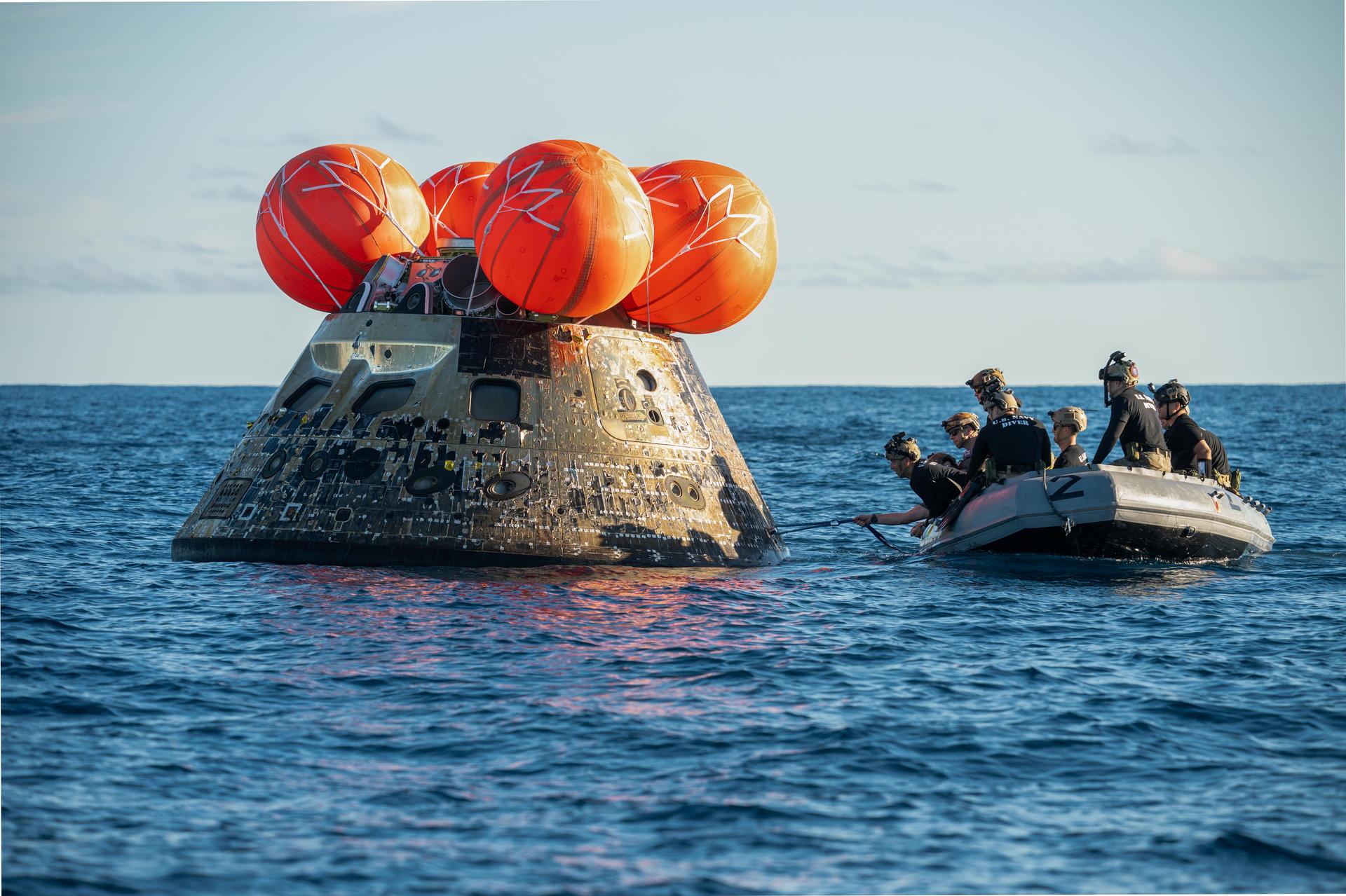 NASA’s Landing and Recovery team, along with U.S. Navy personnel aboard an inflatable raft approach NASA’s Orion spacecraft carrying Artemis II Commander Reid Wiseman, Pilot Victor Glover, and Mission Specialist Christina Koch from NASA, along with Mission Specialist Jeremy Hansen from the CSA (Canadian Space Agency), following splashdown in the Pacific Ocean near San Diego, California, at 5:07 p.m. PDT, (8:07 p.m. EDT) on Friday, April 10, 2026. The Artemis II test flight launched on Wednesday, April 1, from NASA’s Kennedy Space Center in Florida to begin its 10-day journey around the Moon for scientific discovery, economic benefits, and to build on our foundation for the first crewed missions to Mars. NASA’s Landing and Recovery team and the U.S. military are helping the Artemis II crew out of their Orion spacecraft. 