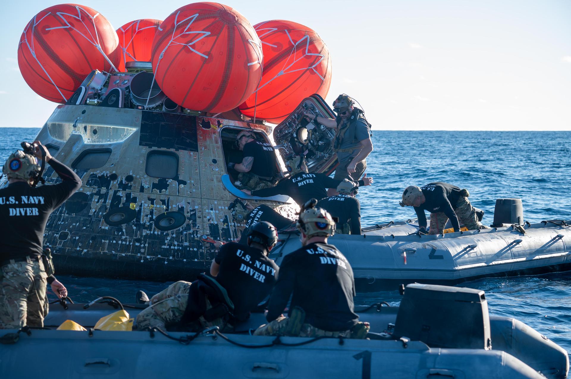 NASA’s Landing and Recovery team, along with U.S. Navy personnel aboard an inflatable raft approach NASA’s Orion spacecraft carrying Artemis II Commander Reid Wiseman, Pilot Victor Glover, and Mission Specialist Christina Koch from NASA, along with Mission Specialist Jeremy Hansen from the CSA (Canadian Space Agency), following splashdown in the Pacific Ocean near San Diego, California, at 5:07 p.m. PDT, (8:07 p.m. EDT) on Friday, April 10, 2026. The Artemis II test flight launched on Wednesday, April 1, from NASA’s Kennedy Space Center in Florida to begin its 10-day journey around the Moon for scientific discovery, economic benefits, and to build on our foundation for the first crewed missions to Mars. NASA’s Landing and Recovery team and the U.S. military are helping the Artemis II crew out of their Orion spacecraft. 