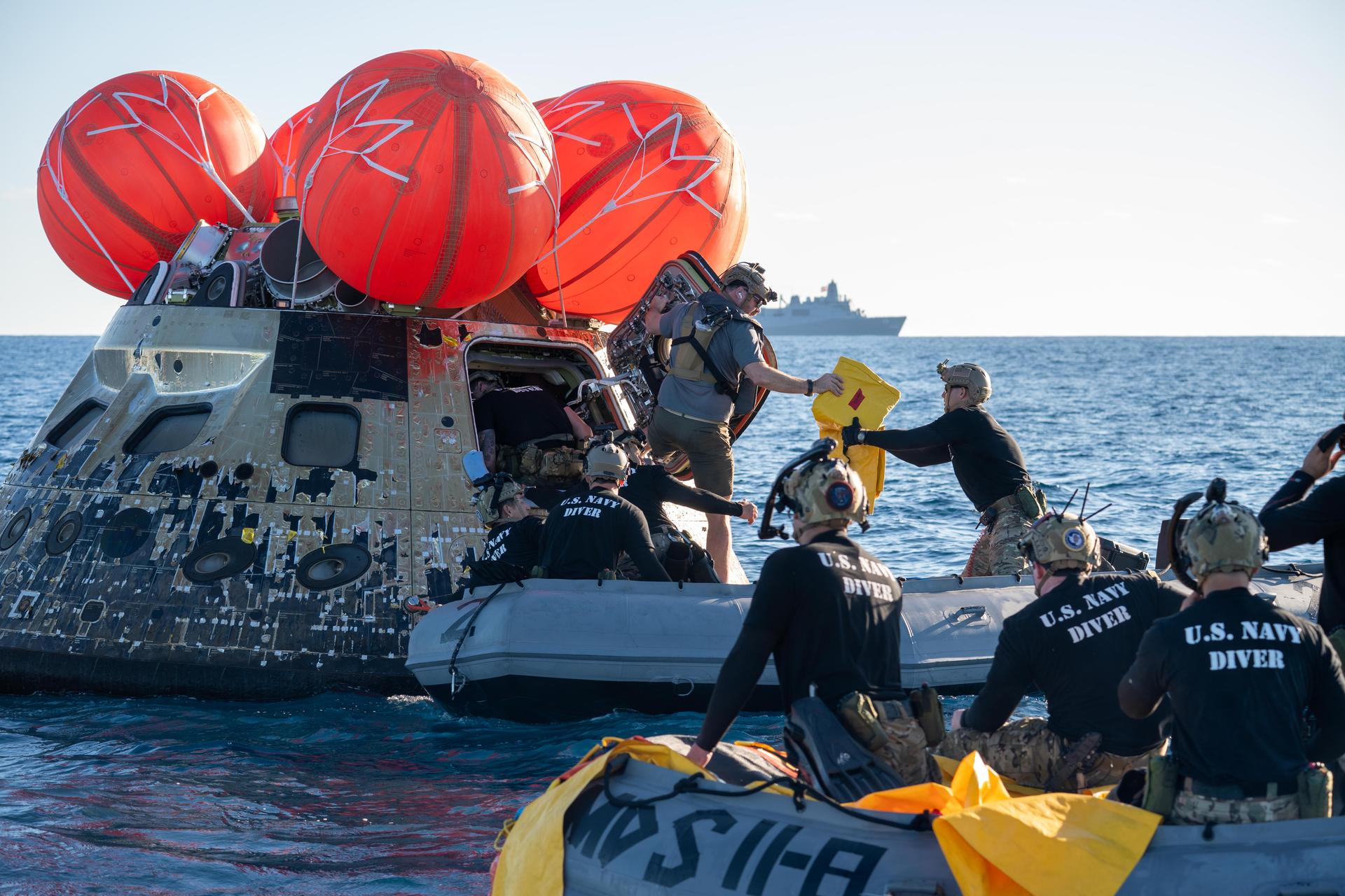 NASA’s Landing and Recovery team, along with U.S. Navy personnel aboard an inflatable raft approach NASA’s Orion spacecraft carrying Artemis II Commander Reid Wiseman, Pilot Victor Glover, and Mission Specialist Christina Koch from NASA, along with Mission Specialist Jeremy Hansen from the CSA (Canadian Space Agency), following splashdown in the Pacific Ocean near San Diego, California, at 5:07 p.m. PDT, (8:07 p.m. EDT) on Friday, April 10, 2026. The Artemis II test flight launched on Wednesday, April 1, from NASA’s Kennedy Space Center in Florida to begin its 10-day journey around the Moon for scientific discovery, economic benefits, and to build on our foundation for the first crewed missions to Mars. NASA’s Landing and Recovery team and the U.S. military are helping the Artemis II crew out of their Orion spacecraft. 