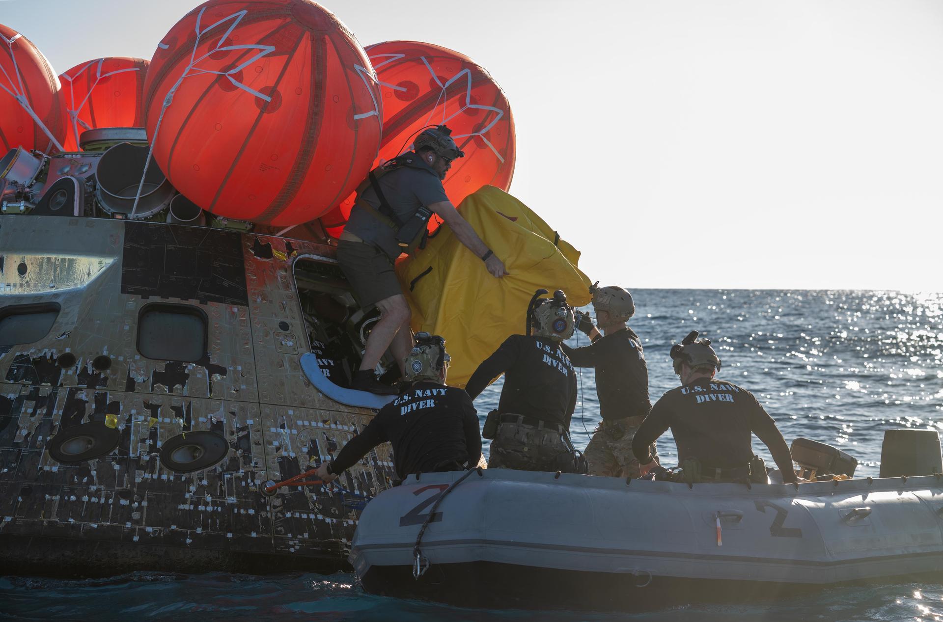 NASA’s Landing and Recovery team, along with U.S. Navy personnel aboard an inflatable raft approach NASA’s Orion spacecraft carrying Artemis II Commander Reid Wiseman, Pilot Victor Glover, and Mission Specialist Christina Koch from NASA, along with Mission Specialist Jeremy Hansen from the CSA (Canadian Space Agency), following splashdown in the Pacific Ocean near San Diego, California, at 5:07 p.m. PDT, (8:07 p.m. EDT) on Friday, April 10, 2026. The Artemis II test flight launched on Wednesday, April 1, from NASA’s Kennedy Space Center in Florida to begin its 10-day journey around the Moon for scientific discovery, economic benefits, and to build on our foundation for the first crewed missions to Mars. NASA’s Landing and Recovery team and the U.S. military are helping the Artemis II crew out of their Orion spacecraft. 
