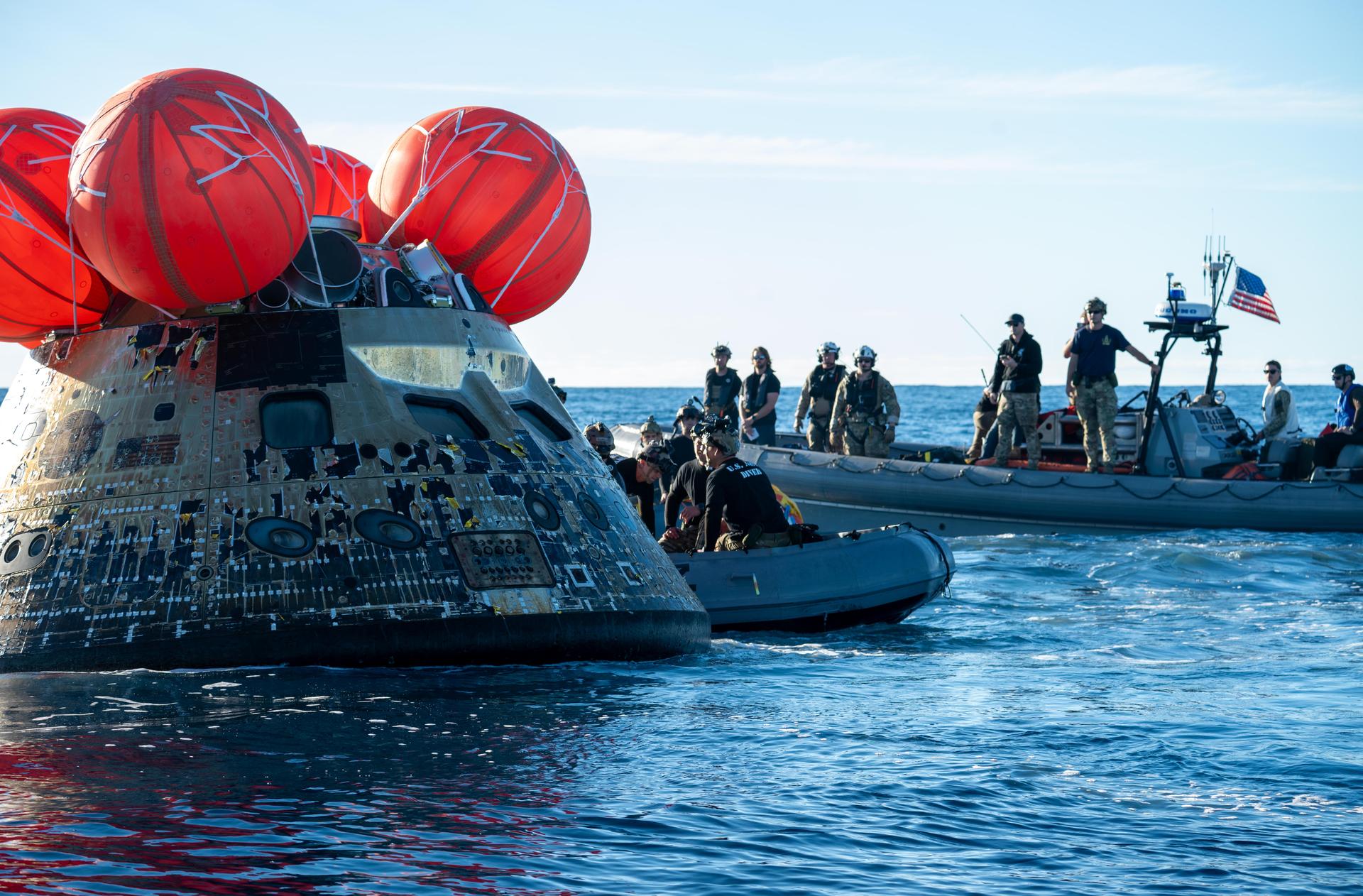 NASA’s Landing and Recovery team, along with U.S. Navy personnel aboard an inflatable raft approach NASA’s Orion spacecraft carrying Artemis II Commander Reid Wiseman, Pilot Victor Glover, and Mission Specialist Christina Koch from NASA, along with Mission Specialist Jeremy Hansen from the CSA (Canadian Space Agency), following splashdown in the Pacific Ocean near San Diego, California, at 5:07 p.m. PDT, (8:07 p.m. EDT) on Friday, April 10, 2026. The Artemis II test flight launched on Wednesday, April 1, from NASA’s Kennedy Space Center in Florida to begin its 10-day journey around the Moon for scientific discovery, economic benefits, and to build on our foundation for the first crewed missions to Mars. NASA’s Landing and Recovery team and the U.S. military are helping the Artemis II crew out of their Orion spacecraft. 