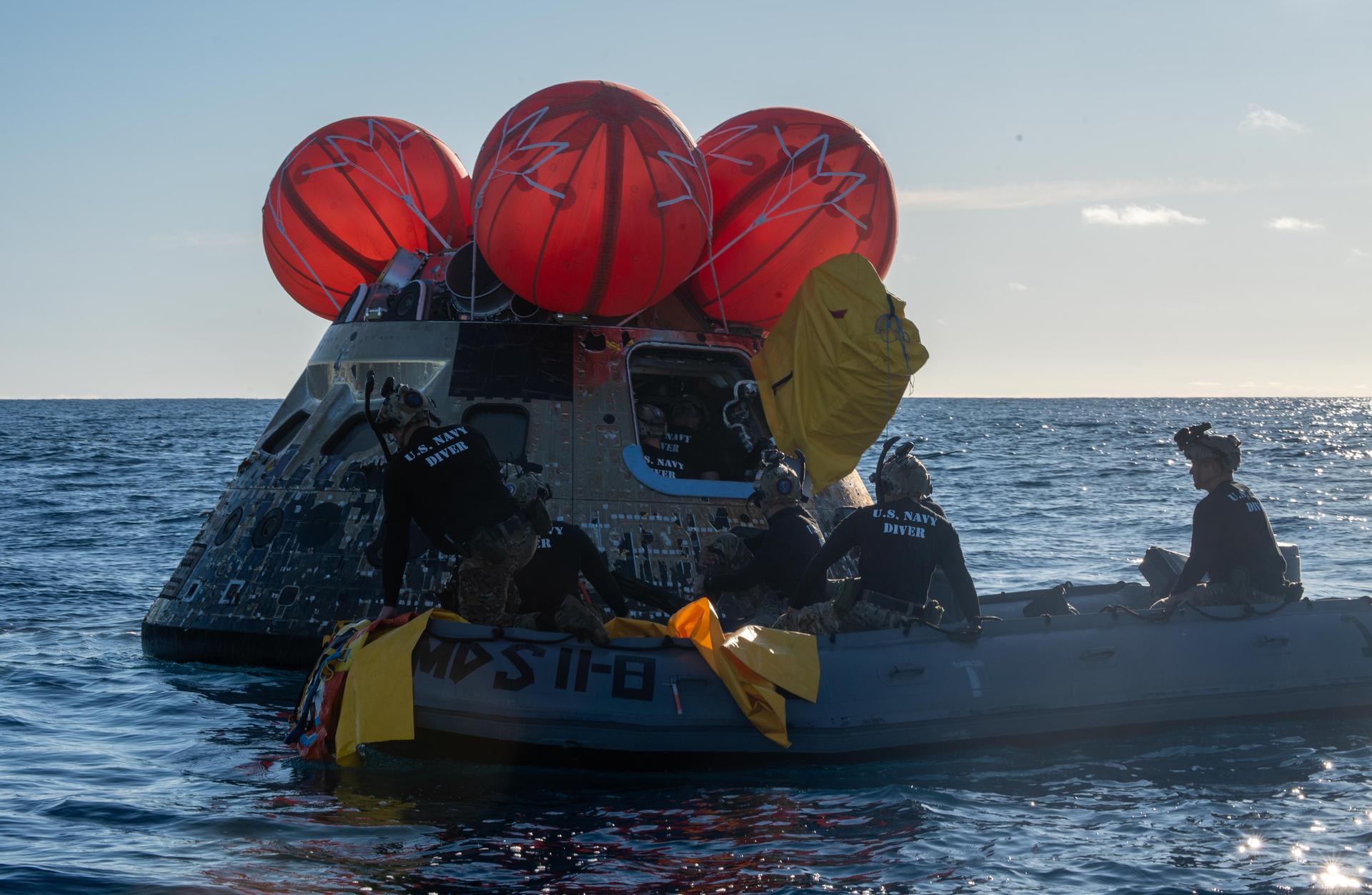 NASA’s Landing and Recovery team, along with U.S. Navy personnel aboard an inflatable raft approach NASA’s Orion spacecraft carrying Artemis II Commander Reid Wiseman, Pilot Victor Glover, and Mission Specialist Christina Koch from NASA, along with Mission Specialist Jeremy Hansen from the CSA (Canadian Space Agency), following splashdown in the Pacific Ocean near San Diego, California, at 5:07 p.m. PDT, (8:07 p.m. EDT) on Friday, April 10, 2026. The Artemis II test flight launched on Wednesday, April 1, from NASA’s Kennedy Space Center in Florida to begin its 10-day journey around the Moon for scientific discovery, economic benefits, and to build on our foundation for the first crewed missions to Mars. NASA’s Landing and Recovery team and the U.S. military are helping the Artemis II crew out of their Orion spacecraft. 