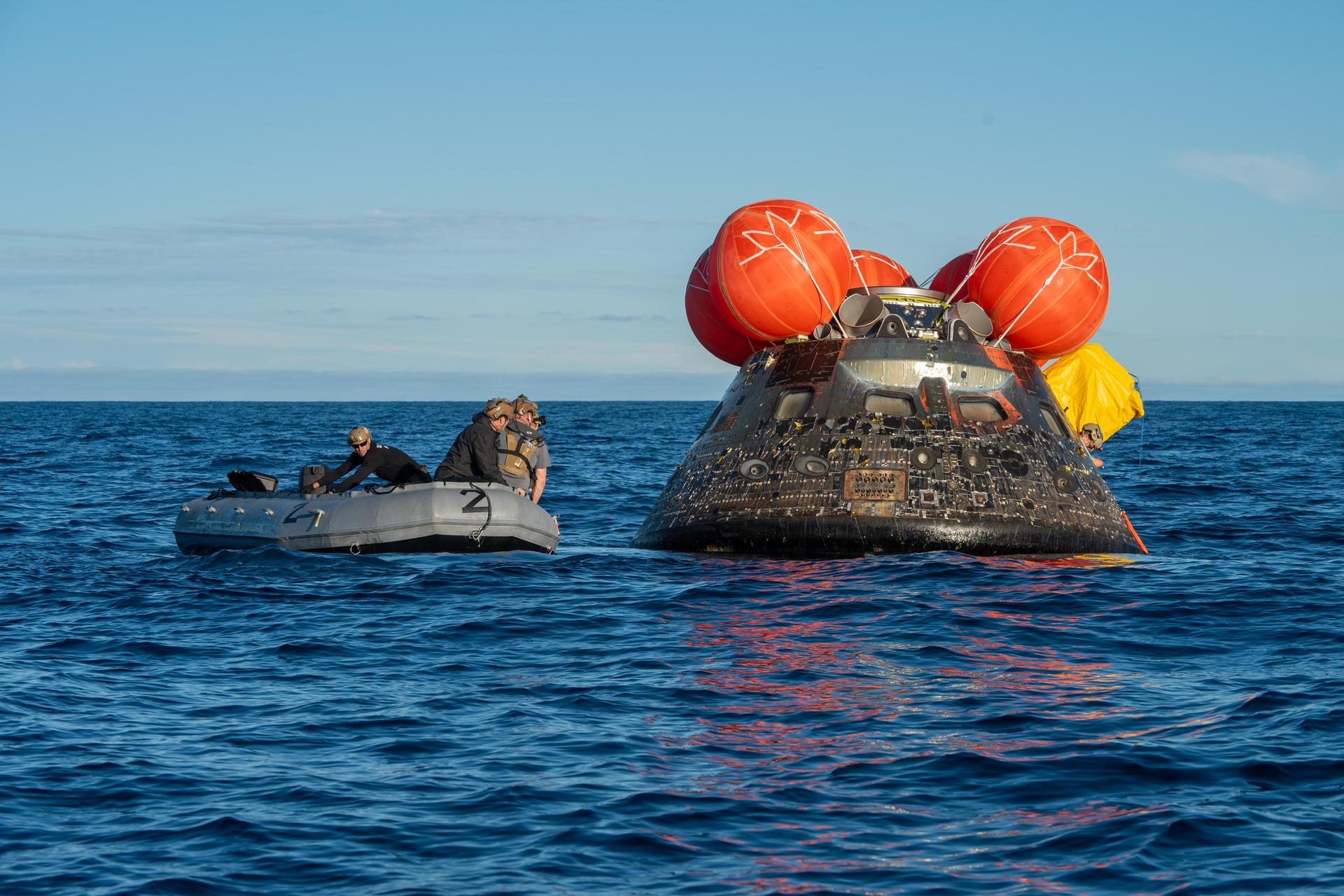 NASA’s Landing and Recovery team, along with U.S. Navy personnel aboard an inflatable raft approach NASA’s Orion spacecraft carrying Artemis II Commander Reid Wiseman, Pilot Victor Glover, and Mission Specialist Christina Koch from NASA, along with Mission Specialist Jeremy Hansen from the CSA (Canadian Space Agency), following splashdown in the Pacific Ocean near San Diego, California, at 5:07 p.m. PDT, (8:07 p.m. EDT) on Friday, April 10, 2026. The Artemis II test flight launched on Wednesday, April 1, from NASA’s Kennedy Space Center in Florida to begin its 10-day journey around the Moon for scientific discovery, economic benefits, and to build on our foundation for the first crewed missions to Mars. NASA’s Landing and Recovery team and the U.S. military are helping the Artemis II crew out of their Orion spacecraft. 