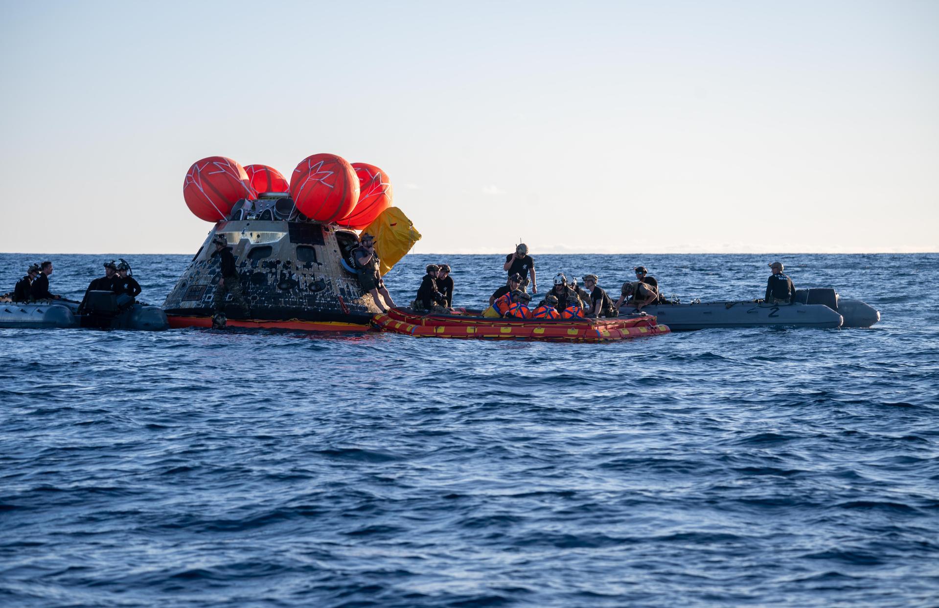 From left to right, Artemis II Commander Reid Wiseman, Mission Specialist Jeremy Hansen from the CSA (Canadian Space Agency), Pilot Victor Glover, and Mission Specialist Christina Koch from NASA, are extracted from NASA’s Orion spacecraft and loaded onto an inflatable raft, called the front porch, following splashdown in the Pacific Ocean near San Diego, California, at 5:07 p.m. PDT, (8:07 p.m. EDT) on Friday, April 10, 2026. The Artemis II crew will be taken to USS John P. Murtha to be routinely examined while NASA’s Landing and Recovery team and the U.S. Navy recover Orion and secure it in the well deck of USS John P. Murtha. The Artemis II test flight launched on Wednesday, April 1, from NASA’s Kennedy Space Center in Florida to begin its 10-day journey around the Moon for scientific discovery, economic benefits, and to build on our foundation for the first crewed missions to Mars.
