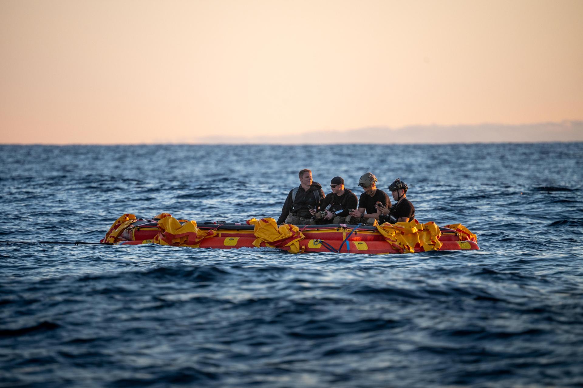 U.S. Navy personnel aboard an inflatable raft, called the front porch, help recover NASA's Orion spacecraft following its splashdown in the Pacific Ocean near San Diego, California, at 5:07 p.m. PDT, (8:07 p.m. EDT) on Friday, April 10, 2026, after the Artemis II test flight. The Artemis II mission carrying Artemis II Commander Reid Wiseman, Pilot Victor Glover, and Mission Specialist Christina Koch from NASA, along with Mission Specialist Jeremy Hansen from the CSA (Canadian Space Agency), launched on Wednesday, April 1, from NASA’s Kennedy Space Center in Florida to begin its 10-day journey around the Moon for scientific discovery, economic benefits, and to build on our foundation for the first crewed missions to Mars. NASA’s Landing and Recovery team and the U.S. Navy are coordinating efforts to secure Orion in the well deck of USS John P. Murtha.