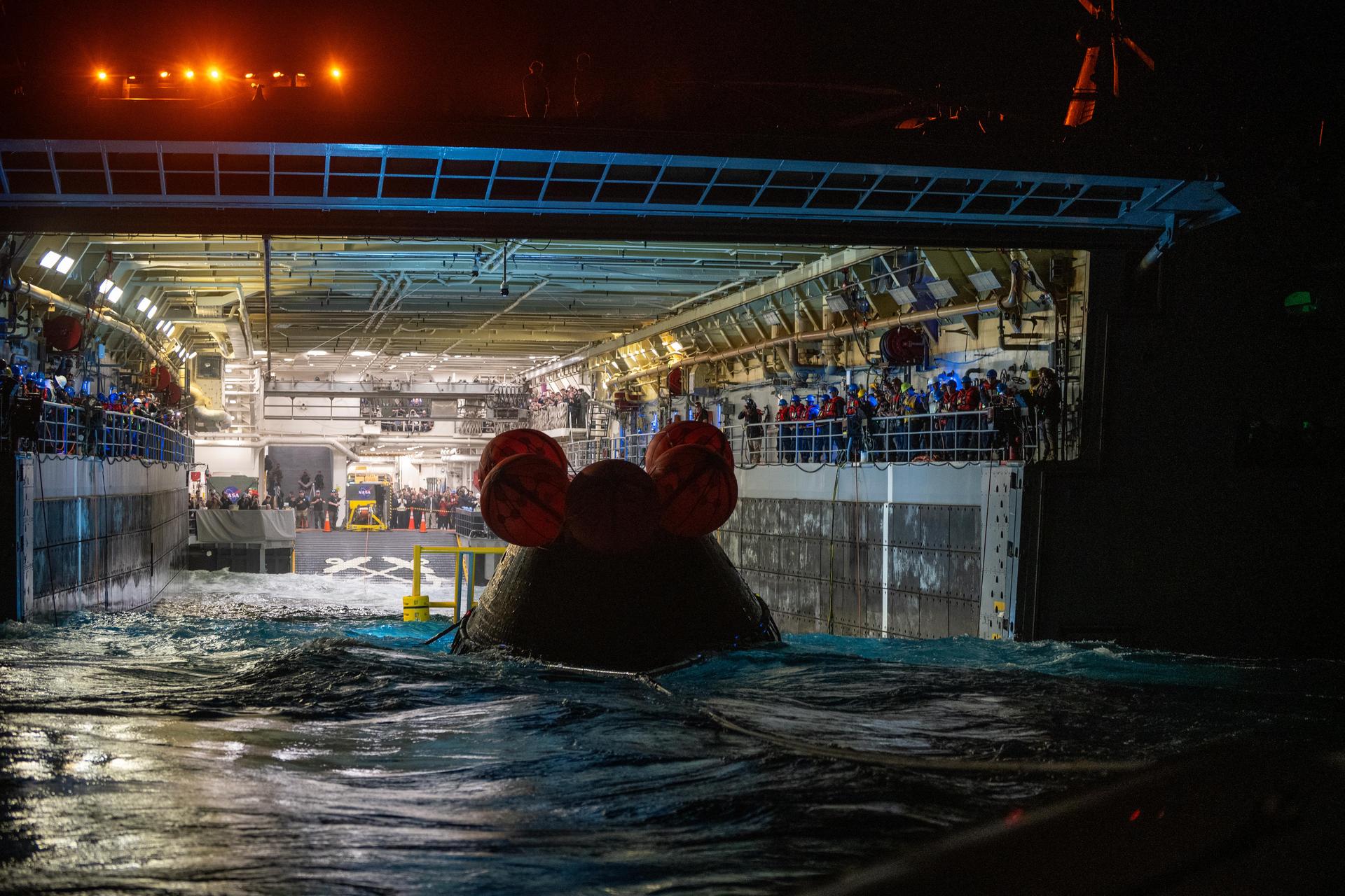 NASA’s Landing and Recovery team and U.S. Navy personnel tow and secure NASA’s Orion spacecraft in the well deck of the USS John P. Murtha following splashdown in the Pacific Ocean near San Diego, California, at 5:07 p.m. PDT, (8:07 p.m. EDT) on Friday, April 10, 2026, after the Artemis II test flight. The Artemis II mission carrying Artemis II Commander Reid Wiseman, Pilot Victor Glover, and Mission Specialist Christina Koch from NASA, along with Mission Specialist Jeremy Hansen from the CSA (Canadian Space Agency), launched on Wednesday, April 1, from NASA’s Kennedy Space Center in Florida to begin its 10-day journey around the Moon for scientific discovery, economic benefits, and to build on our foundation for the first crewed missions to Mars. 