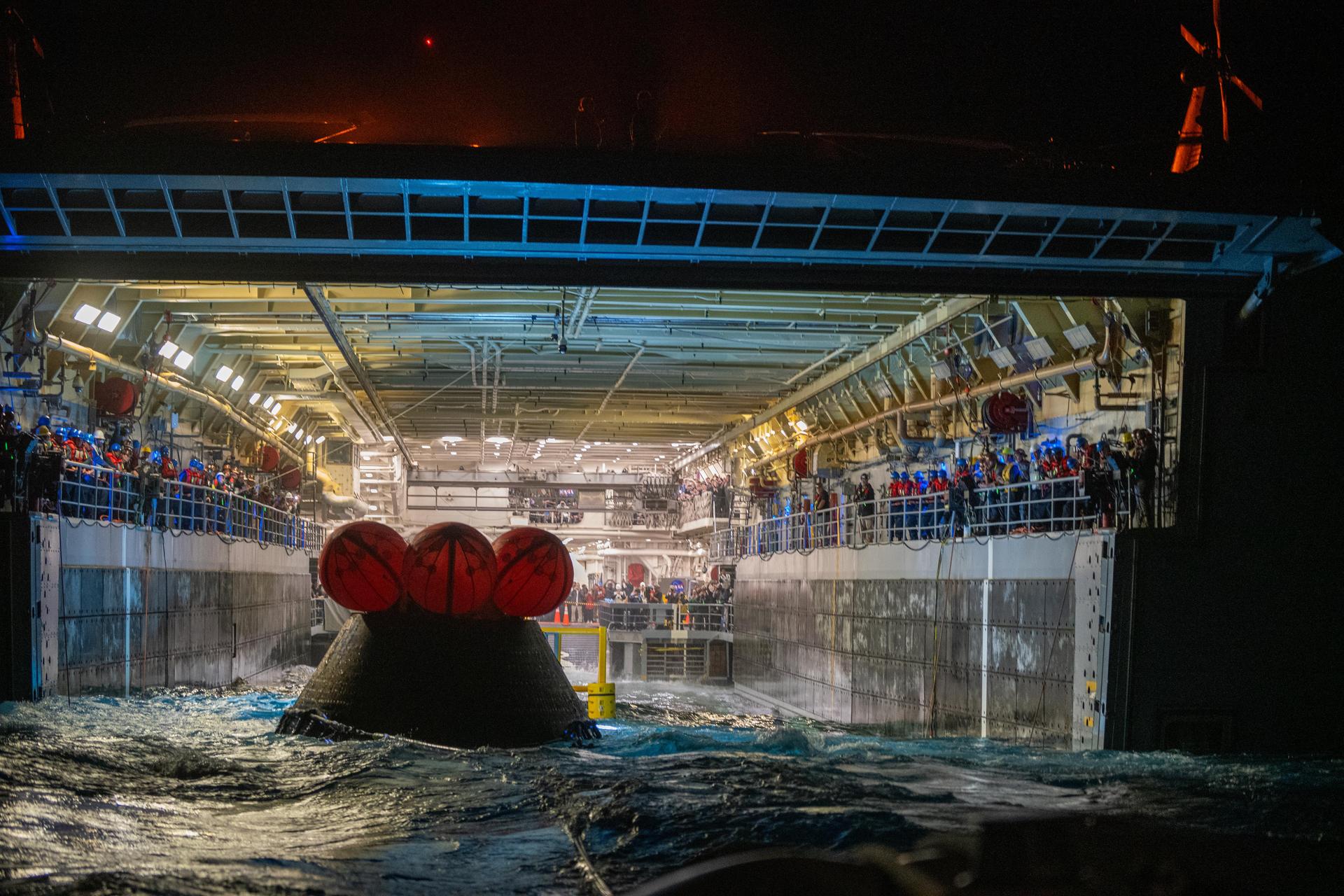 NASA’s Landing and Recovery team and U.S. Navy personnel tow and secure NASA’s Orion spacecraft in the well deck of the USS John P. Murtha following splashdown in the Pacific Ocean near San Diego, California, at 5:07 p.m. PDT, (8:07 p.m. EDT) on Friday, April 10, 2026, after the Artemis II test flight. The Artemis II mission carrying Artemis II Commander Reid Wiseman, Pilot Victor Glover, and Mission Specialist Christina Koch from NASA, along with Mission Specialist Jeremy Hansen from the CSA (Canadian Space Agency), launched on Wednesday, April 1, from NASA’s Kennedy Space Center in Florida to begin its 10-day journey around the Moon for scientific discovery, economic benefits, and to build on our foundation for the first crewed missions to Mars. 