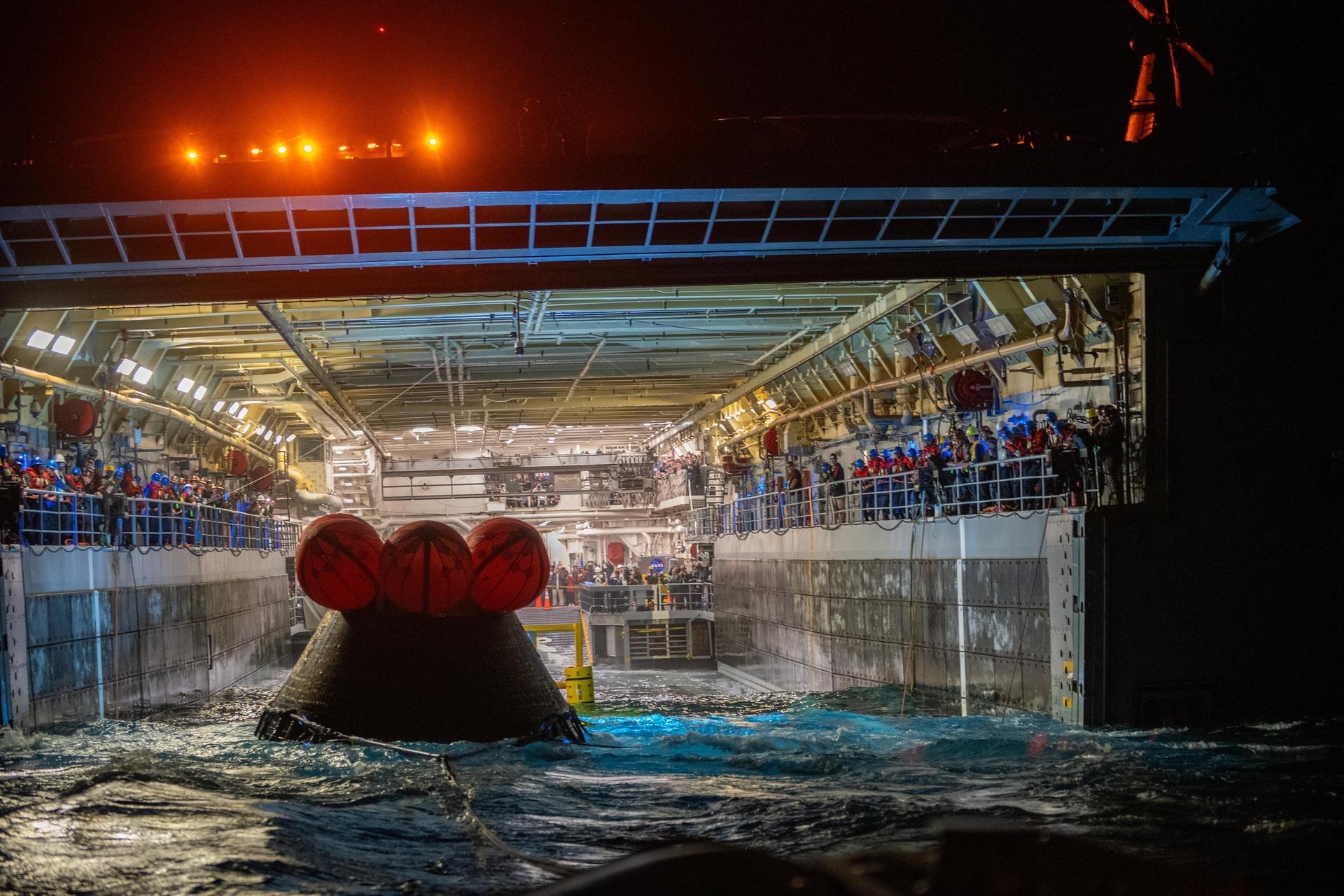NASA’s Landing and Recovery team and U.S. Navy personnel tow and secure NASA’s Orion spacecraft in the well deck of the USS John P. Murtha following splashdown in the Pacific Ocean near San Diego, California, at 5:07 p.m. PDT, (8:07 p.m. EDT) on Friday, April 10, 2026, after the Artemis II test flight. The Artemis II mission carrying Artemis II Commander Reid Wiseman, Pilot Victor Glover, and Mission Specialist Christina Koch from NASA, along with Mission Specialist Jeremy Hansen from the CSA (Canadian Space Agency), launched on Wednesday, April 1, from NASA’s Kennedy Space Center in Florida to begin its 10-day journey around the Moon for scientific discovery, economic benefits, and to build on our foundation for the first crewed missions to Mars. 