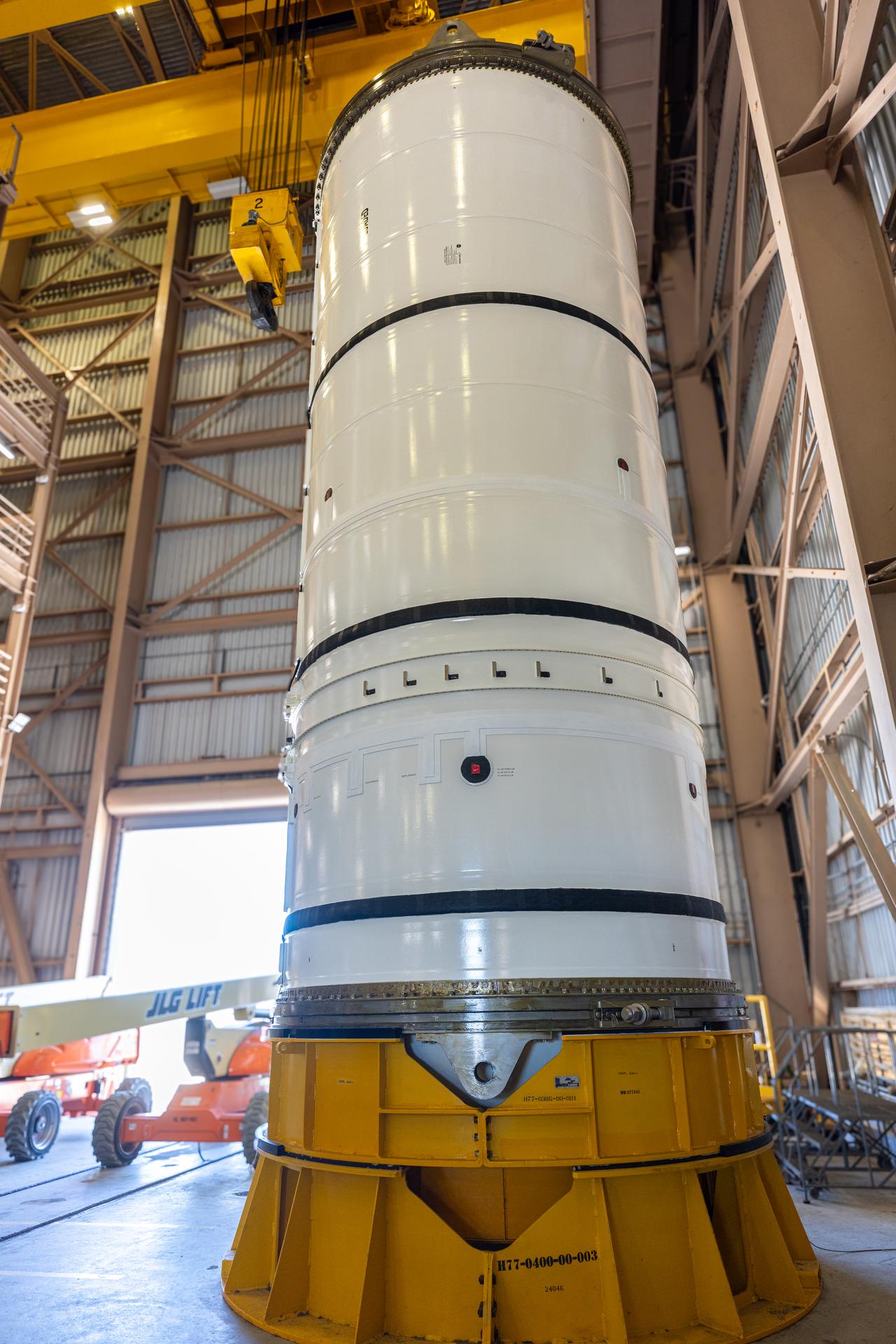 The left-hand forward solid rocket booster segment for NASA’s Artemis III SLS (Space Launch System) rocket is removed from its shipping container ahead of processing inside the Rotation, Processing and Surge Facility at the agency’s Kennedy Space Center in Florida on Wednesday, April 15, 2026. The SLS rocket’s twin boosters, manufactured by Northrop Grumman in Utah, will provide more than 75 percent of the SLS rocket’s total thrust at launch. The Artemis III mission will launch crew in the Orion spacecraft on top of the SLS rocket to test rendezvous and docking capabilities between Orion and commercial spacecraft needed to land astronauts on the Moon. 