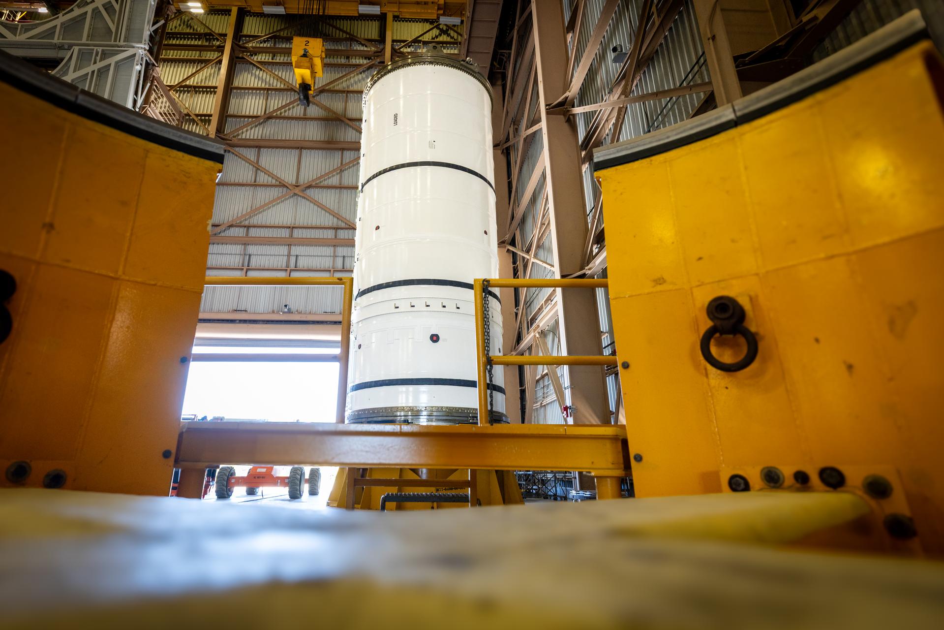 The left-hand forward solid rocket booster segment for NASA’s Artemis III SLS (Space Launch System) rocket is removed from its shipping container ahead of processing inside the Rotation, Processing and Surge Facility at the agency’s Kennedy Space Center in Florida on Wednesday, April 15, 2026. The SLS rocket’s twin boosters, manufactured by Northrop Grumman in Utah, will provide more than 75 percent of the SLS rocket’s total thrust at launch. The Artemis III mission will launch crew in the Orion spacecraft on top of the SLS rocket to test rendezvous and docking capabilities between Orion and commercial spacecraft needed to land astronauts on the Moon. 