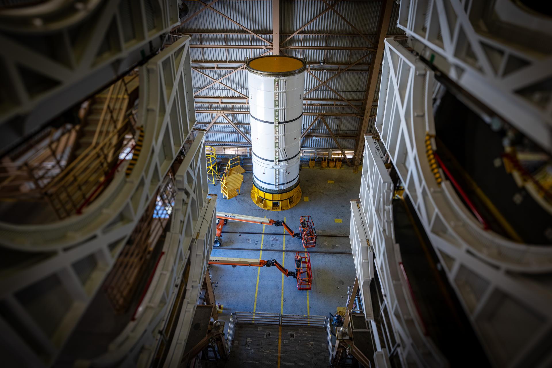 The left-hand forward solid rocket booster segment for NASA’s Artemis III SLS (Space Launch System) rocket is removed from its shipping container ahead of processing inside the Rotation, Processing and Surge Facility at the agency’s Kennedy Space Center in Florida on Wednesday, April 15, 2026. The SLS rocket’s twin boosters, manufactured by Northrop Grumman in Utah, will provide more than 75 percent of the SLS rocket’s total thrust at launch. The Artemis III mission will launch crew in the Orion spacecraft on top of the SLS rocket to test rendezvous and docking capabilities between Orion and commercial spacecraft needed to land astronauts on the Moon. 