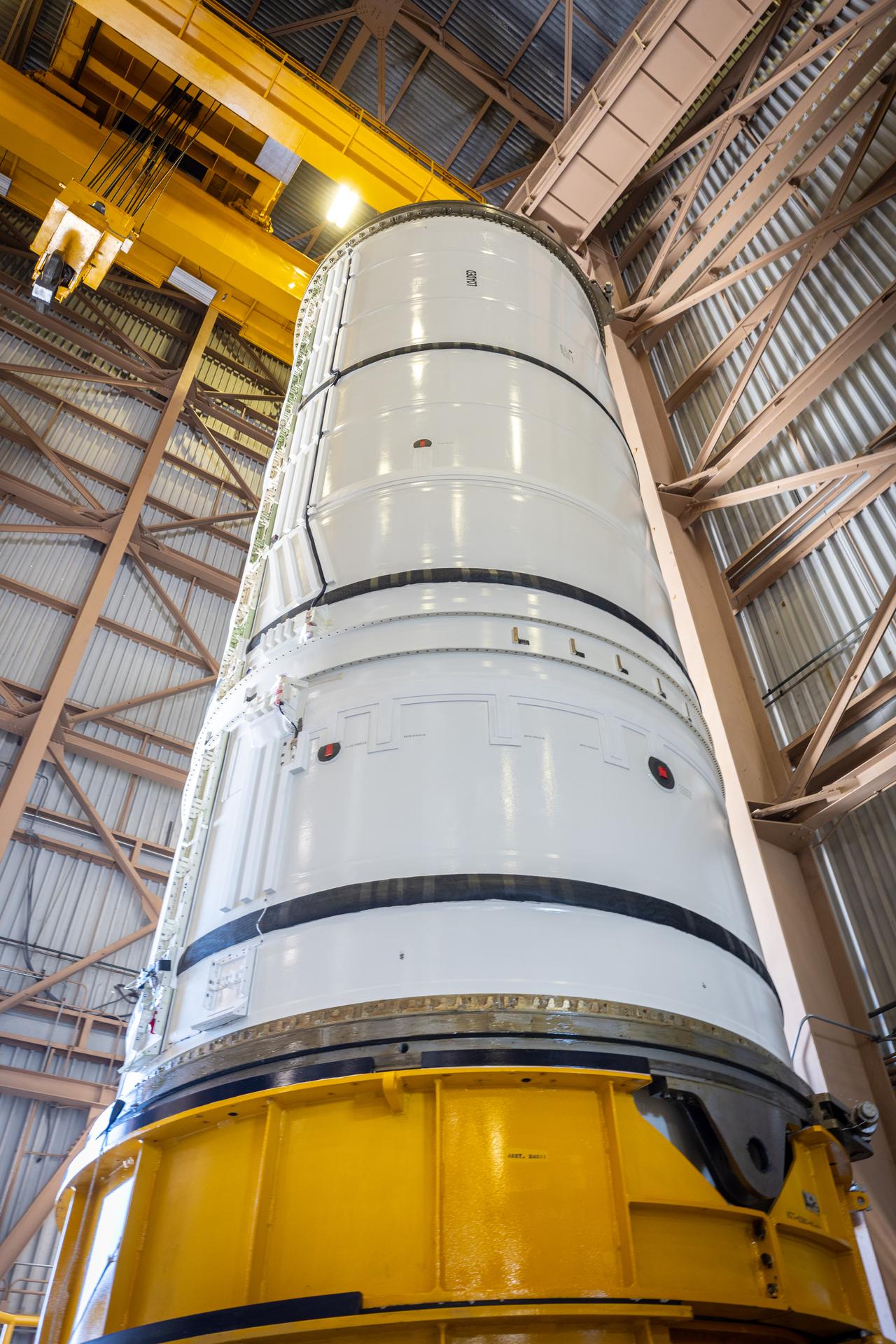 The left-hand forward solid rocket booster segment for NASA’s Artemis III SLS (Space Launch System) rocket is removed from its shipping container ahead of processing inside the Rotation, Processing and Surge Facility at the agency’s Kennedy Space Center in Florida on Wednesday, April 15, 2026. The SLS rocket’s twin boosters, manufactured by Northrop Grumman in Utah, will provide more than 75 percent of the SLS rocket’s total thrust at launch. The Artemis III mission will launch crew in the Orion spacecraft on top of the SLS rocket to test rendezvous and docking capabilities between Orion and commercial spacecraft needed to land astronauts on the Moon. 