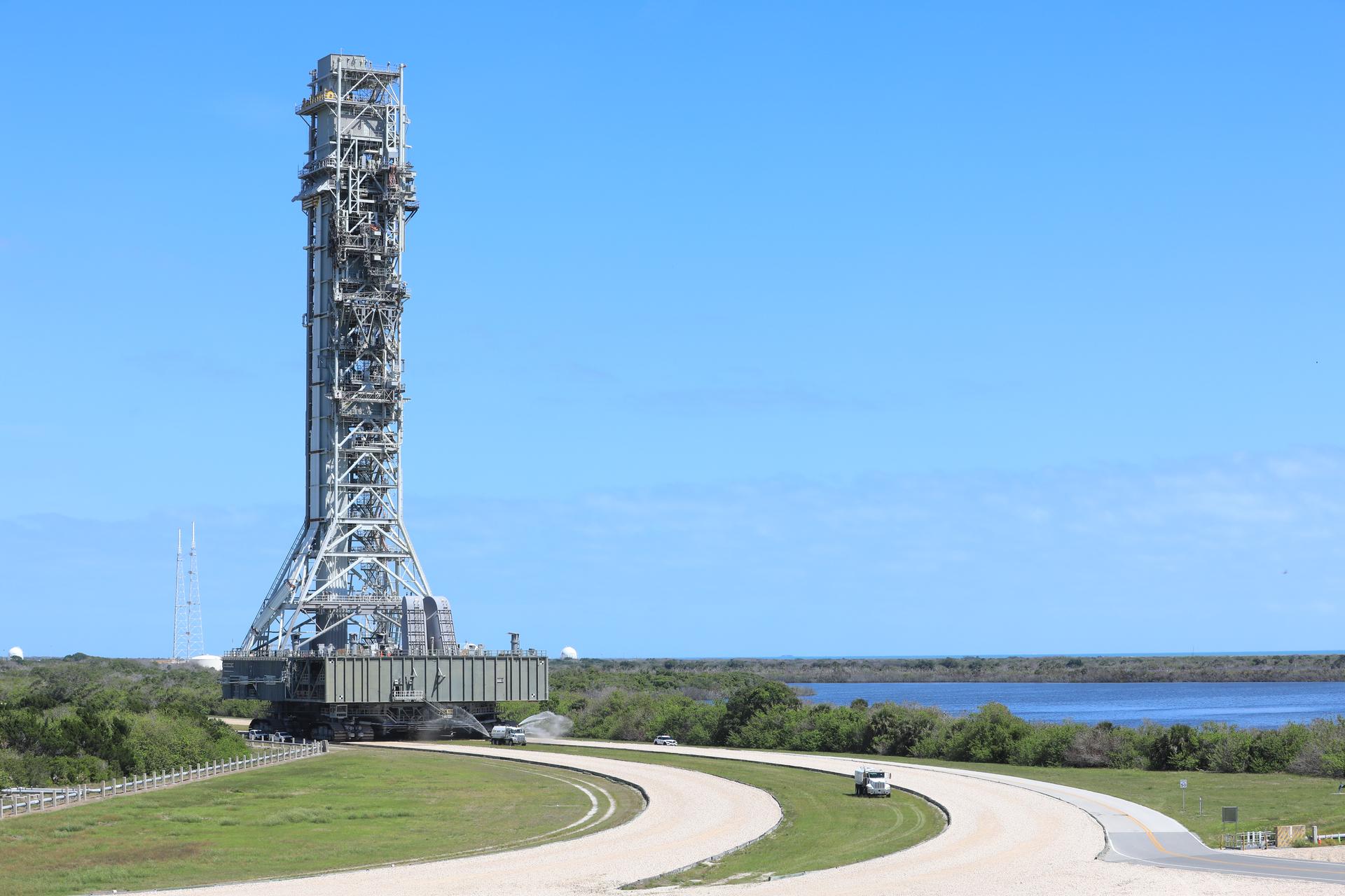 NASA’s mobile launcher 1 begins its approximately 4-mile trek from Launch Complex 39B to the Vehicle Assembly Building at the agency’s Kennedy Space Center in Florida on Thursday, April 16, 2026, in preparation for Artemis III stacking operations. Teams will perform checkouts, inspections, and data analysis, and make repairs to the tower that saw damage during liftoff of the Artemis II test flight.  