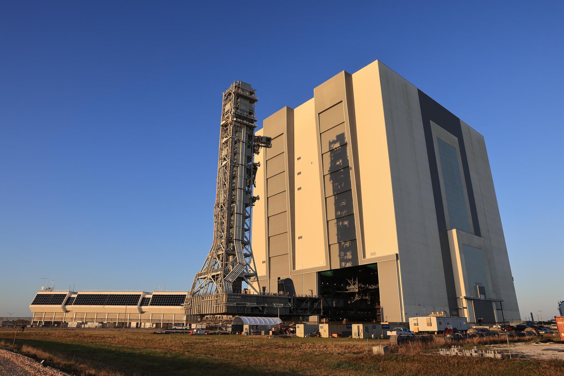 NASA’s mobile launcher approaches the Vehicle Assembly Building following its approximately 4-mile trek from Launch Complex 39B at the agency’s Kennedy Space Center in Florida on Friday, April 17, 2026, in preparation for Artemis III stacking operations. Teams will perform checkouts, inspections, and data analysis, and make repairs to the tower that saw damage during launch of NASA’s Artemis II test flight on April 1, 2026.  