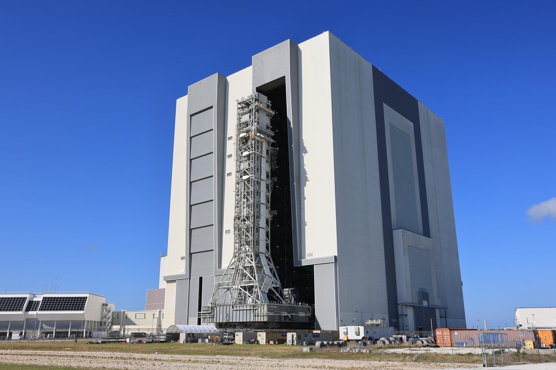 NASA’s mobile launcher approaches the Vehicle Assembly Building following its approximately 4-mile trek from Launch Complex 39B at the agency’s Kennedy Space Center in Florida on Friday, April 17, 2026, in preparation for Artemis III stacking operations. Teams will perform checkouts, inspections, and data analysis, and make repairs to the tower that saw damage during launch of NASA’s Artemis II test flight on April 1, 2026.  