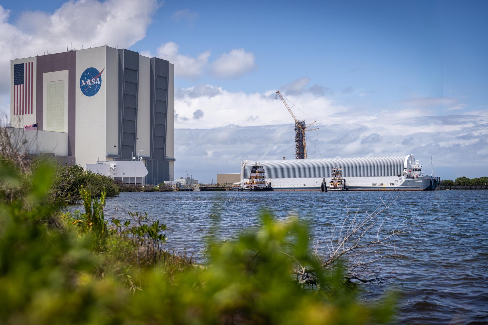 NASA’s Pegasus barge, carrying the top four-fifths of the agency’s SLS (Space Launch System) core stage for the Artemis III mission, arrives at NASA’s Kennedy Space Center Complex 39 turn basin wharf in Florida on Monday, April 27, 2026. Artemis III will launch astronauts to Earth’s orbit aboard the Orion spacecraft on top of SLS to test rendezvous and docking capabilities between Orion and commercial spacecraft needed to land Artemis IV astronauts on the Moon in 2028. 