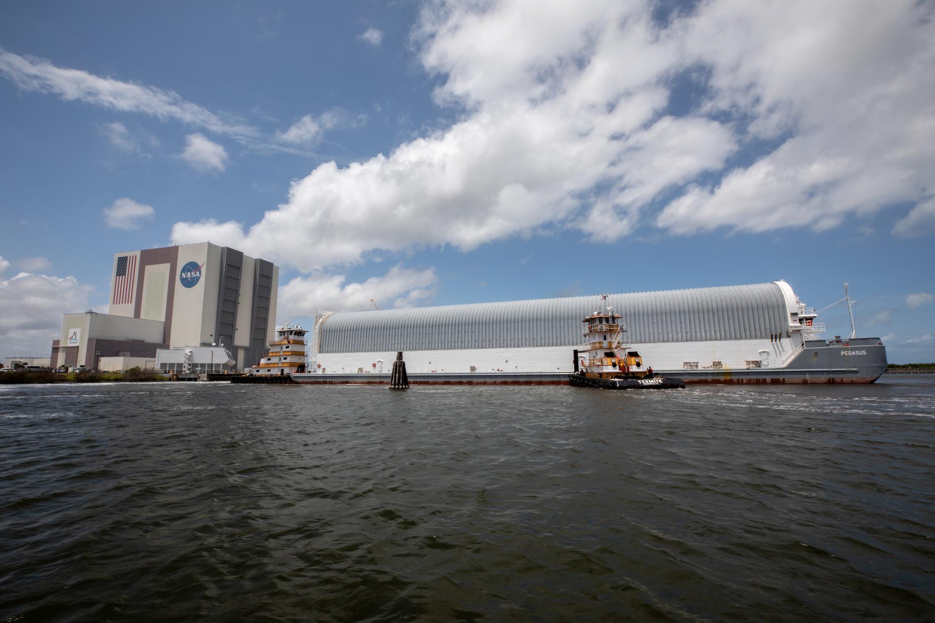 NASA’s Pegasus barge, carrying the top four-fifths of the agency’s SLS (Space Launch System) core stage for the Artemis III mission, arrives at NASA’s Kennedy Space Center Complex 39 turn basin wharf in Florida on Monday, April 27, 2026. Artemis III will launch astronauts to Earth’s orbit aboard the Orion spacecraft on top of SLS to test rendezvous and docking capabilities between Orion and commercial spacecraft needed to land Artemis IV astronauts on the Moon in 2028. 