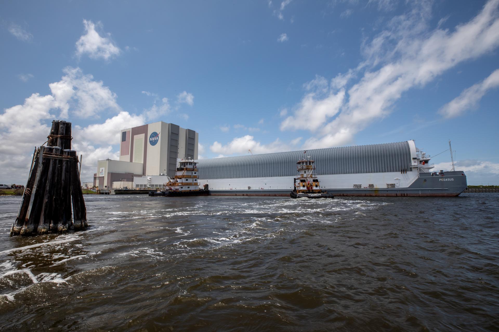 NASA’s Pegasus barge, carrying the top four-fifths of the agency’s SLS (Space Launch System) core stage for the Artemis III mission, arrives at NASA’s Kennedy Space Center Complex 39 turn basin wharf in Florida on Monday, April 27, 2026. Artemis III will launch astronauts to Earth’s orbit aboard the Orion spacecraft on top of SLS to test rendezvous and docking capabilities between Orion and commercial spacecraft needed to land Artemis IV astronauts on the Moon in 2028. 