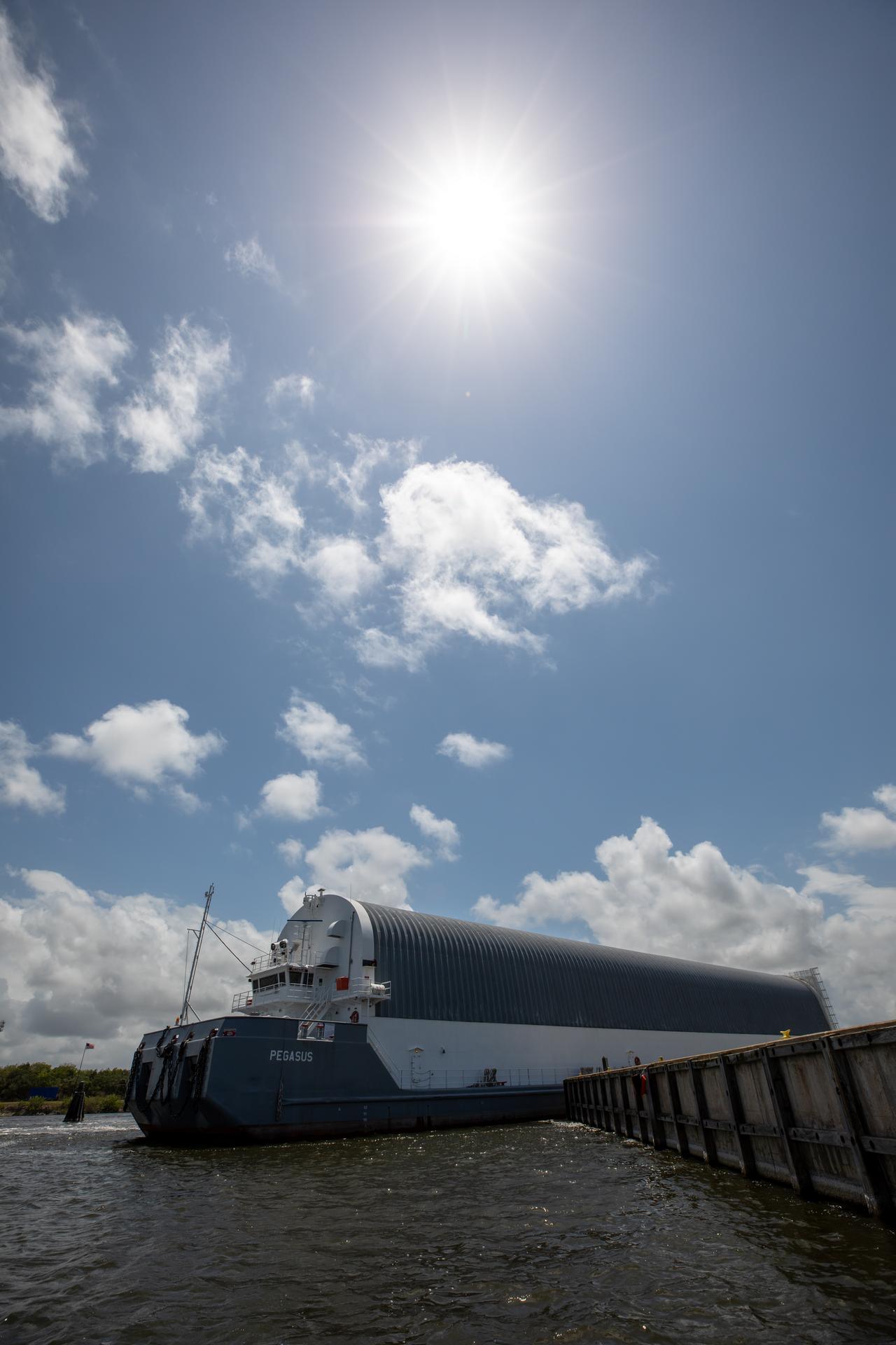 NASA’s Pegasus barge, carrying the top four-fifths of the agency’s SLS (Space Launch System) core stage for the Artemis III mission, arrives at NASA’s Kennedy Space Center Complex 39 turn basin wharf in Florida on Monday, April 27, 2026. Artemis III will launch astronauts to Earth’s orbit aboard the Orion spacecraft on top of SLS to test rendezvous and docking capabilities between Orion and commercial spacecraft needed to land Artemis IV astronauts on the Moon in 2028. 
