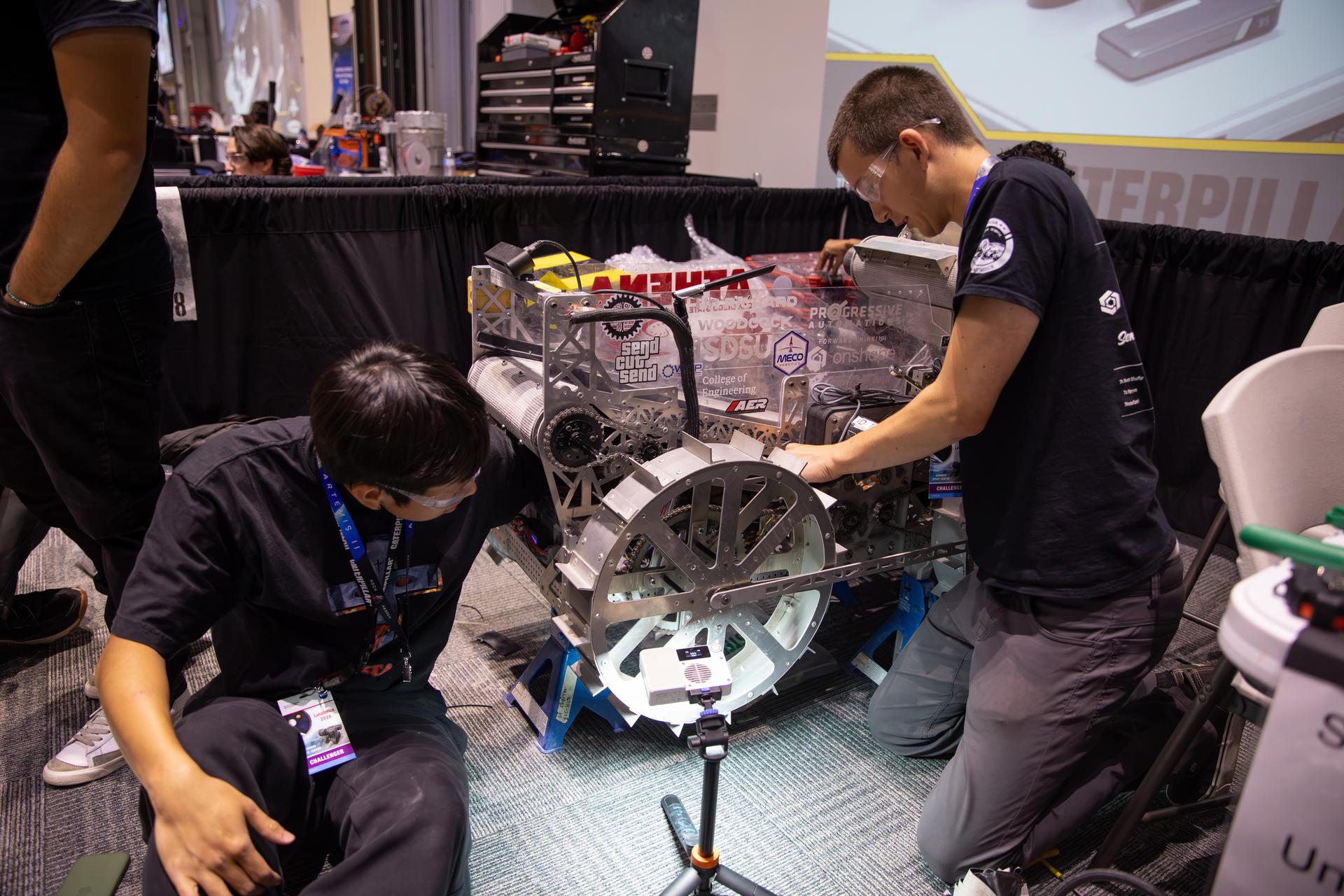 Students from San Diego State University prepare their prototype lunar robot for its turn during the finals for NASA’s 2026 Lunabotics Challenge competition on Tuesday, May 19, 2026, inside the Astronauts Memorial Foundation’s Center for Space Education at the Kennedy Space Center Visitor Complex in Florida. Forty-seven teams from around the U.S. designed and built remote-controlled robots capable of traversing challenging lunar terrain while constructing regolith-based berm under conditions similar to those the agency will face as it returns to the lunar surface through Artemis.