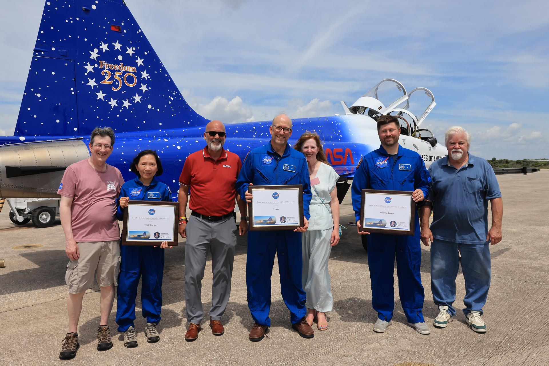 As part of NASA Administrator Jared Isaacman’s Flight Experience Award program, NASA employees Kuo-Chia “Alice” Liu, Raymond “Jim” Lanzi, and Logan Larson receive awards from NASA Kennedy’s Director of Human Capital Office, Mike Beaupre, on Thursday, June 18, 2026, at the Launch and Landing Facility at the agency’s Kennedy Space Center in Florida. Awardees suited up in NASA flight suits, completed pre-flight briefings at the spaceport’s Launch and Landing Facility, received awards from NASA Kennedy’s Director of Human Capital Office, Mike Beaupre, and experienced a unique flight aboard the administrator’s personal F-5 aircraft. The ride-along flight experience award program highlights NASA’s commitment to celebrating excellence across the workforce.