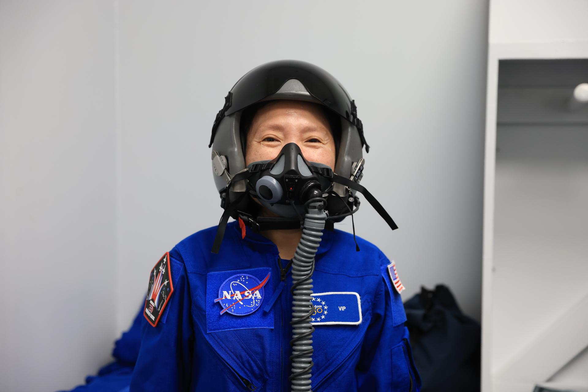 NASA employee Kuo-Chia “Alice” Liu dons a blue NASA flight suit and helmet ahead of her ride-along flight, as part of NASA Administrator Jared Isaacman’s Flight Experience Award program on Thursday, June 18, 2026, at the Launch and Landing Facility at the agency’s Kennedy Space Center in Florida. Liu, with other awardees, suited up, completed pre-flight briefings, and experienced a unique flight aboard the administrator’s personal F-5 aircraft. The ride-along flight experience award program highlights NASA’s commitment to celebrating excellence across the workforce.