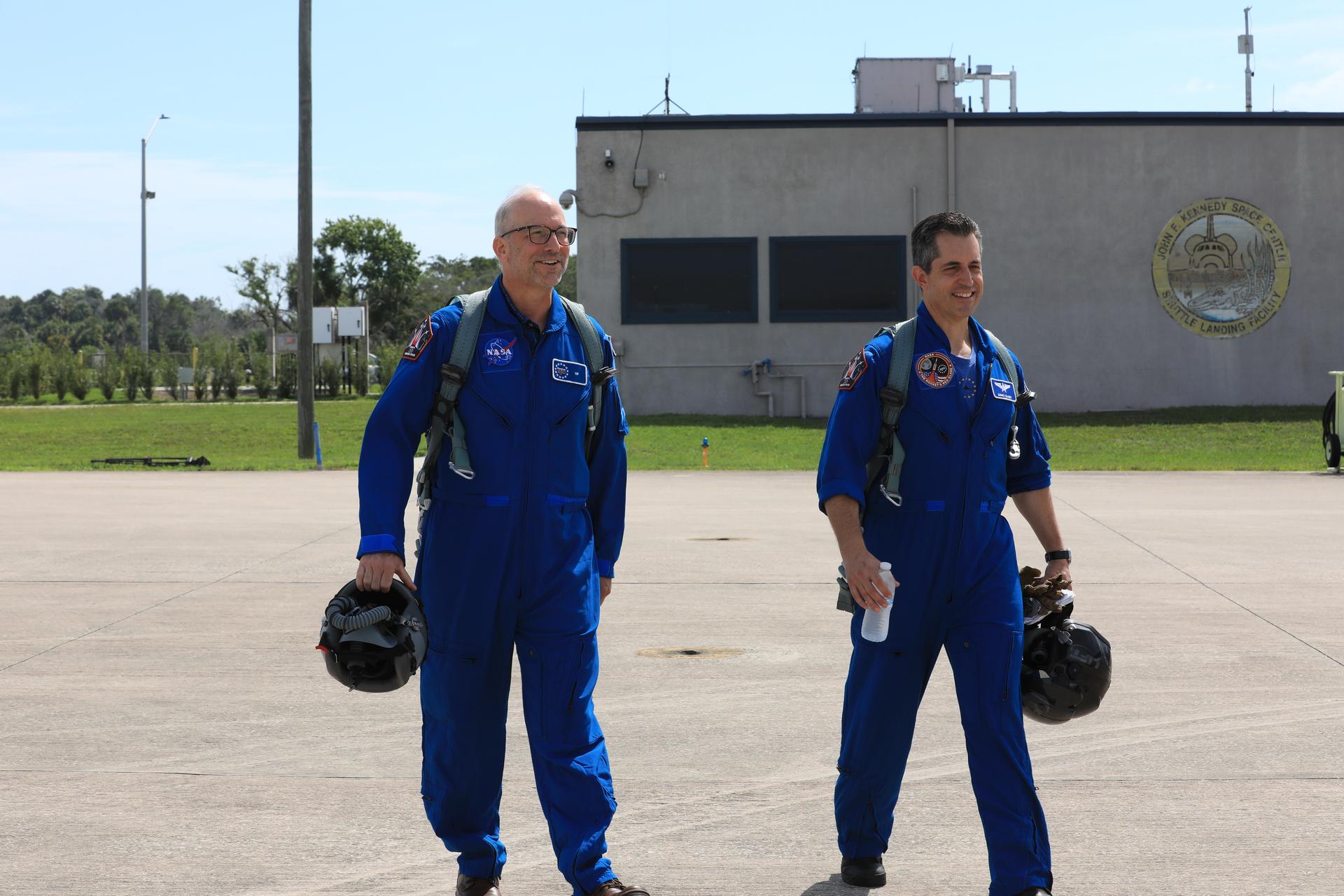 NASA employee Raymond “Jim” Lanzi (left) and Pilot Scott Glaser walk on the tarmac at the Launch and Landing Facility at the agency’s Kennedy Space Center in Florida on Thursday, June 18, 2026. As part of the NASA Administrator Jared Isaacman’s Flight Experience Award program, Lanzi, along with other awardees, suited up, completed pre-flight briefings, and experienced a unique flight aboard the Administrator’s personal F-5 aircraft. The ride-along flight experience award program highlights NASA’s commitment to celebrating excellence across the workforce.