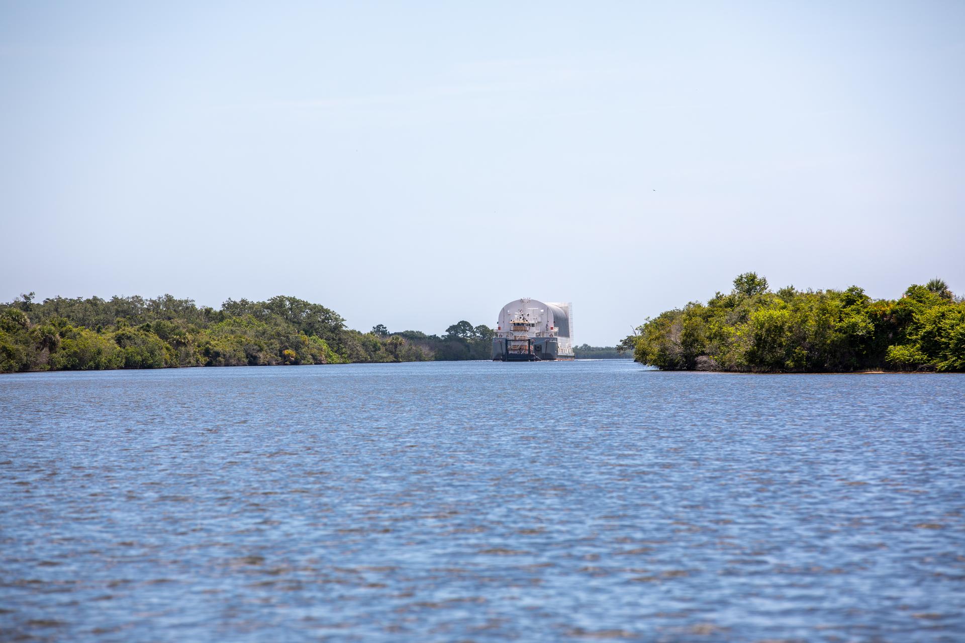 NASA’s Pegasus barge arrives at the Launch Complex 39 turn basin at the agency’s Kennedy Space Center in Florida carrying NASA’s Nancy Grace Roman Space Telescope on Sunday, June 21, 2026. Teams will offload and transport the observatory to the spaceport’s Payload Hazardous Servicing Facility where it will undergo processing ahead of launch, targeted no earlier than Sunday, Aug. 30, 2026. Named for NASA’s first chief astronomer and “mother of the Hubble Space Telescope,” Roman will offer a field of view over 100 times larger than Hubble’s to study up to a billion galaxies, directly image exoplanets and planet forming disks, and address fundamental questions about dark energy, exoplanets, and infrared astrophysics.