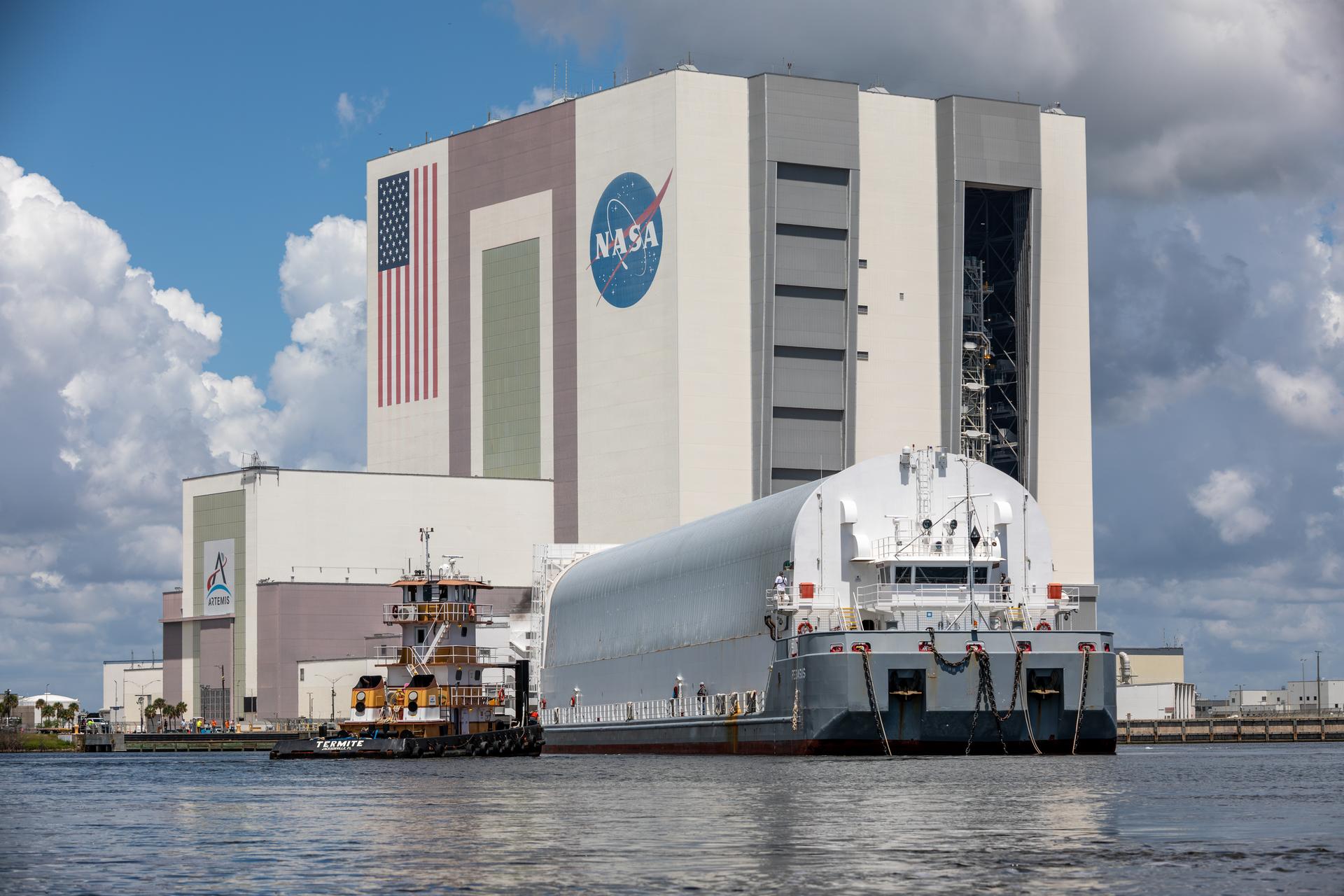 NASA’s Pegasus barge arrives at the Launch Complex 39 turn basin at the agency’s Kennedy Space Center in Florida carrying NASA’s Nancy Grace Roman Space Telescope on Sunday, June 21, 2026. Teams will offload and transport the observatory to the spaceport’s Payload Hazardous Servicing Facility where it will undergo processing ahead of launch, targeted no earlier than Sunday, Aug. 30, 2026. Named for NASA’s first chief astronomer and “mother of the Hubble Space Telescope,” Roman will offer a field of view over 100 times larger than Hubble’s to study up to a billion galaxies, directly image exoplanets and planet forming disks, and address fundamental questions about dark energy, exoplanets, and infrared astrophysics.