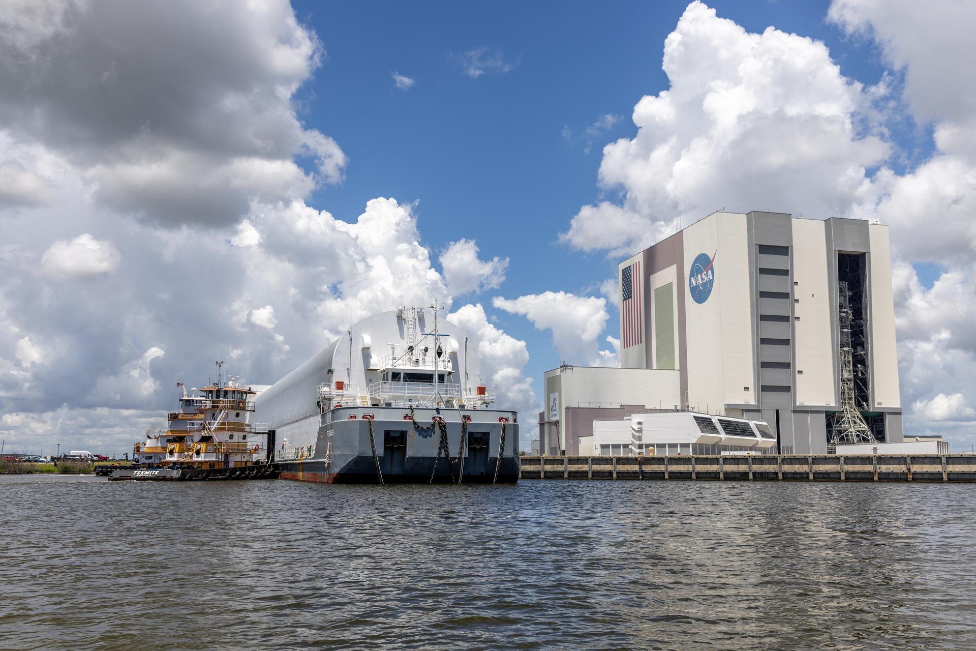 NASA’s Pegasus barge arrives at the Launch Complex 39 turn basin at the agency’s Kennedy Space Center in Florida carrying NASA’s Nancy Grace Roman Space Telescope on Sunday, June 21, 2026. Teams will offload and transport the observatory to the spaceport’s Payload Hazardous Servicing Facility where it will undergo processing ahead of launch, targeted no earlier than Sunday, Aug. 30, 2026. Named for NASA’s first chief astronomer and “mother of the Hubble Space Telescope,” Roman will offer a field of view over 100 times larger than Hubble’s to study up to a billion galaxies, directly image exoplanets and planet forming disks, and address fundamental questions about dark energy, exoplanets, and infrared astrophysics.
