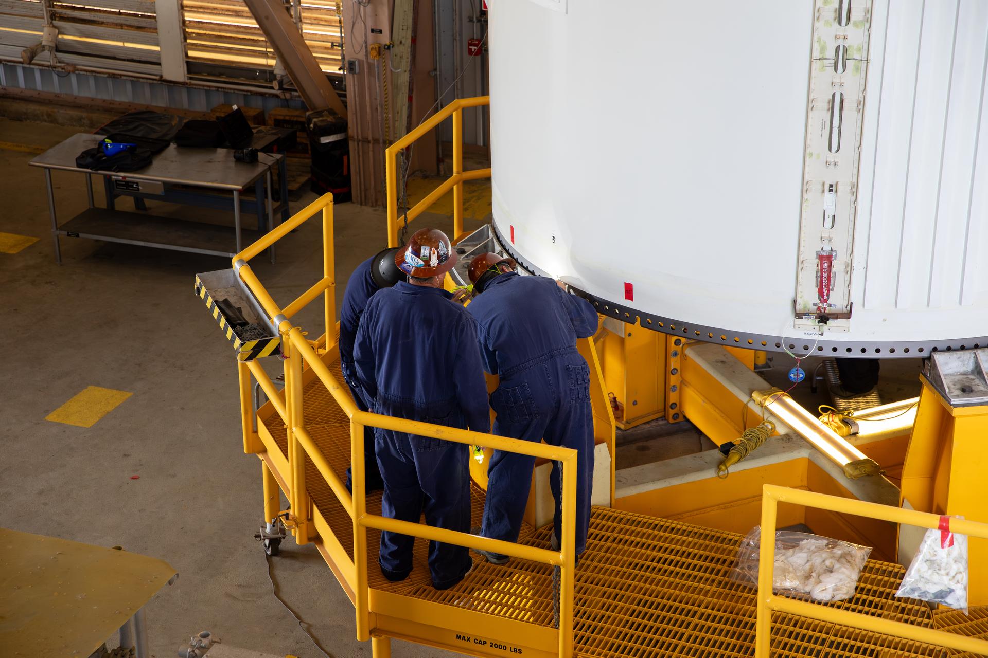 The left-hand forward solid rocket booster segment for NASA’s Artemis III SLS (Space Launch System) rocket is offloaded from its rail car transportation container and inspected ahead of processing inside the Rotation, Processing and Surge Facility at the agency’s Kennedy Space Center in Florida on Tuesday, June 30, 2026. The SLS rocket’s twin boosters, manufactured by Northrop Grumman in Utah, will provide more than 75 percent of the SLS rocket’s total thrust at launch. The Artemis III mission will launch crew in the Orion spacecraft on top of the SLS rocket to test rendezvous and docking capabilities between Orion and commercial spacecraft needed to land astronauts on the Moon.