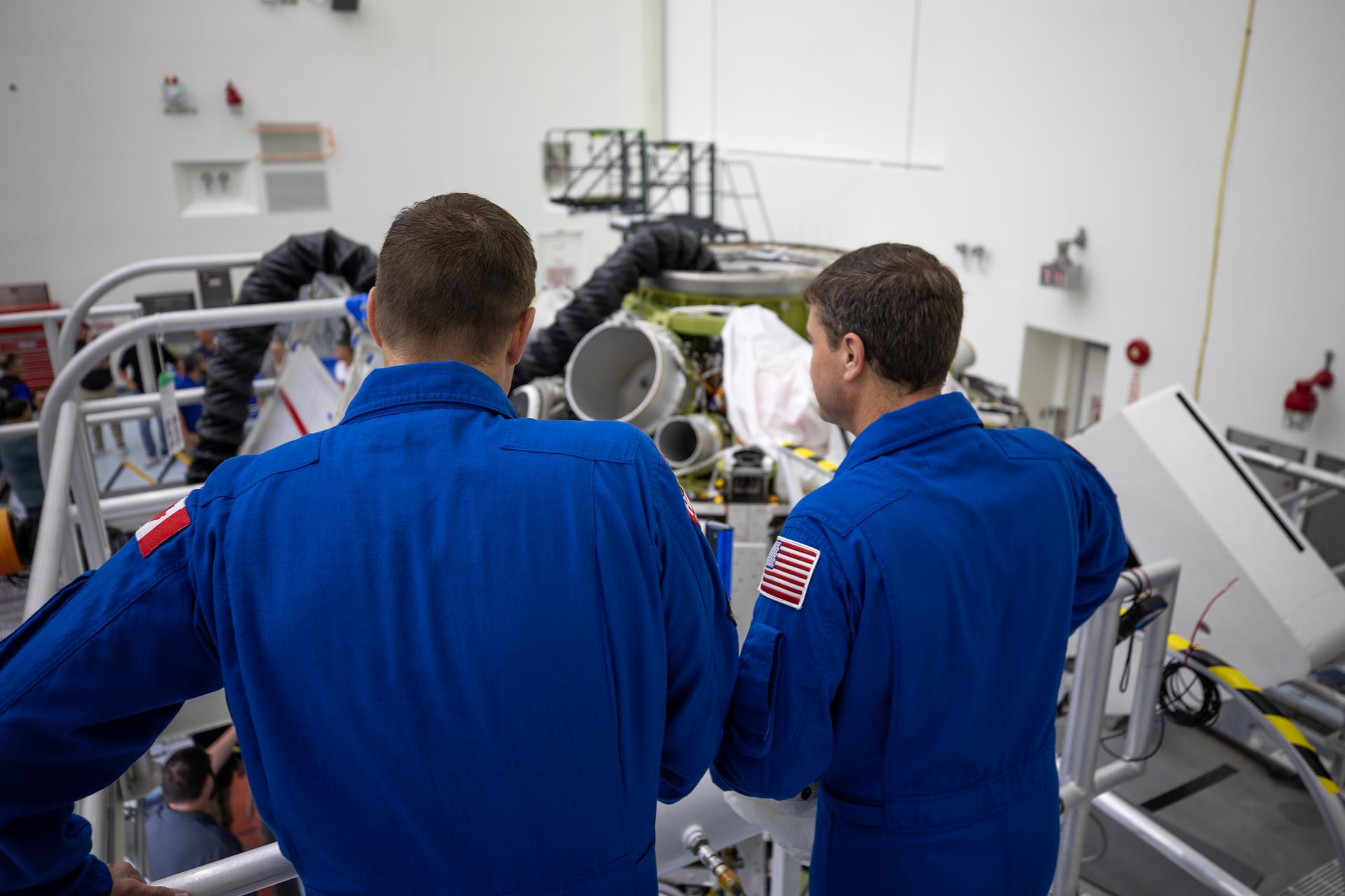 From left, Artemis II CSA (Canadian Space Agency) astronaut Jeremy Hansen and NASA astronaut Reid Wiseman view the Artemis II Orion spacecraft inside the Multi-Payload Processing Facility at NASA’s Kennedy Space Center in Florida on Wednesday, July 8, 2026. Wiseman, Hansen, and Artemis II NASA astronauts Victor Glover and Christina Koch returned to NASA Kennedy for their first official visit since launch of Artemis II on Wednesday, April 1, 2026, to visit with the center’s workforce and tour facilities to view progress on Artemis III prelaunch processing.