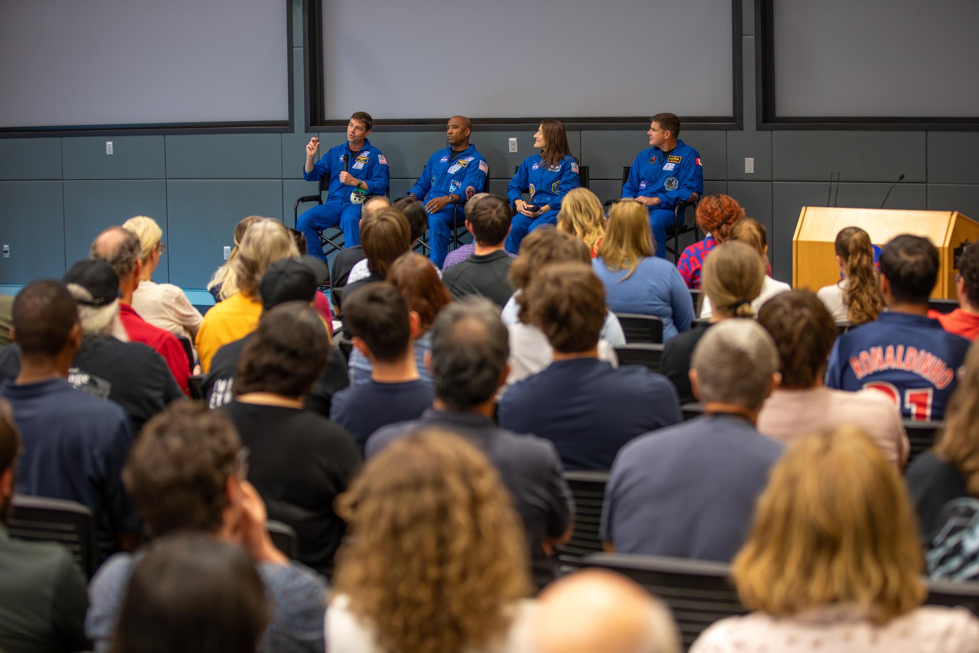 From left, Artemis II NASA astronauts Reid Wiseman, Victor Glover, Christina Koch, along with CSA (Canadian Space Agency) astronaut Jeremy Hansen speak to employees at NASA’s Kennedy Space Center in Florida on Wednesday, July 8, 2026. The crew returned to NASA Kennedy for their first official visit since launch of Artemis II on Wednesday, April 1, 2026, to visit with the center’s workforce and tour facilities to view progress on Artemis III prelaunch processing.