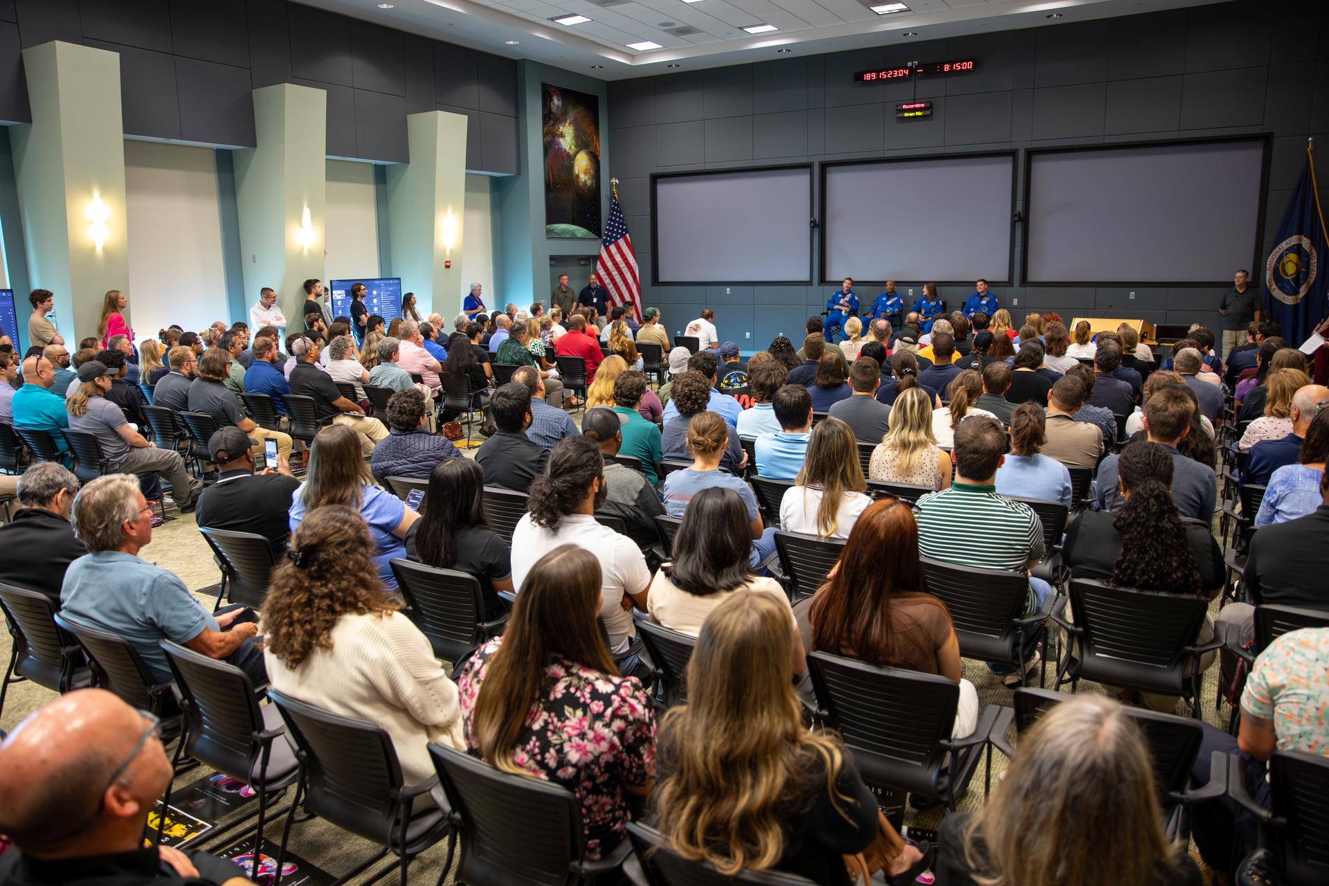 From left, Artemis II NASA astronauts Reid Wiseman, Victor Glover, Christina Koch, along with CSA (Canadian Space Agency) astronaut Jeremy Hansen speak to employees at NASA’s Kennedy Space Center in Florida on Wednesday, July 8, 2026. The crew returned to NASA Kennedy for their first official visit since launch of Artemis II on Wednesday, April 1, 2026, to visit with the center’s workforce and tour facilities to view progress on Artemis III prelaunch processing.