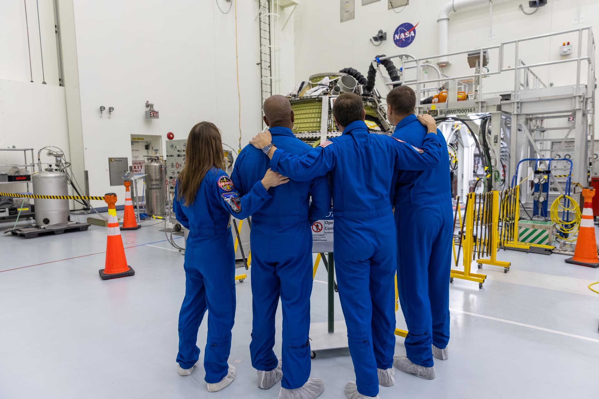 From left, Artemis II NASA astronauts Christina Koch, Victor Glover, and Reid Wiseman, along with CSA (Canadian Space Agency) astronaut Jeremy Hansen view the Artemis II Orion spacecraft inside the Multi-Payload Processing Facility at NASA’s Kennedy Space Center in Florida on Wednesday, July 8, 2026. The crew returned to NASA Kennedy for their first official visit since launch of Artemis II on Wednesday, April 1, 2026, to visit with the center’s workforce and tour facilities to view progress on Artemis III prelaunch processing.