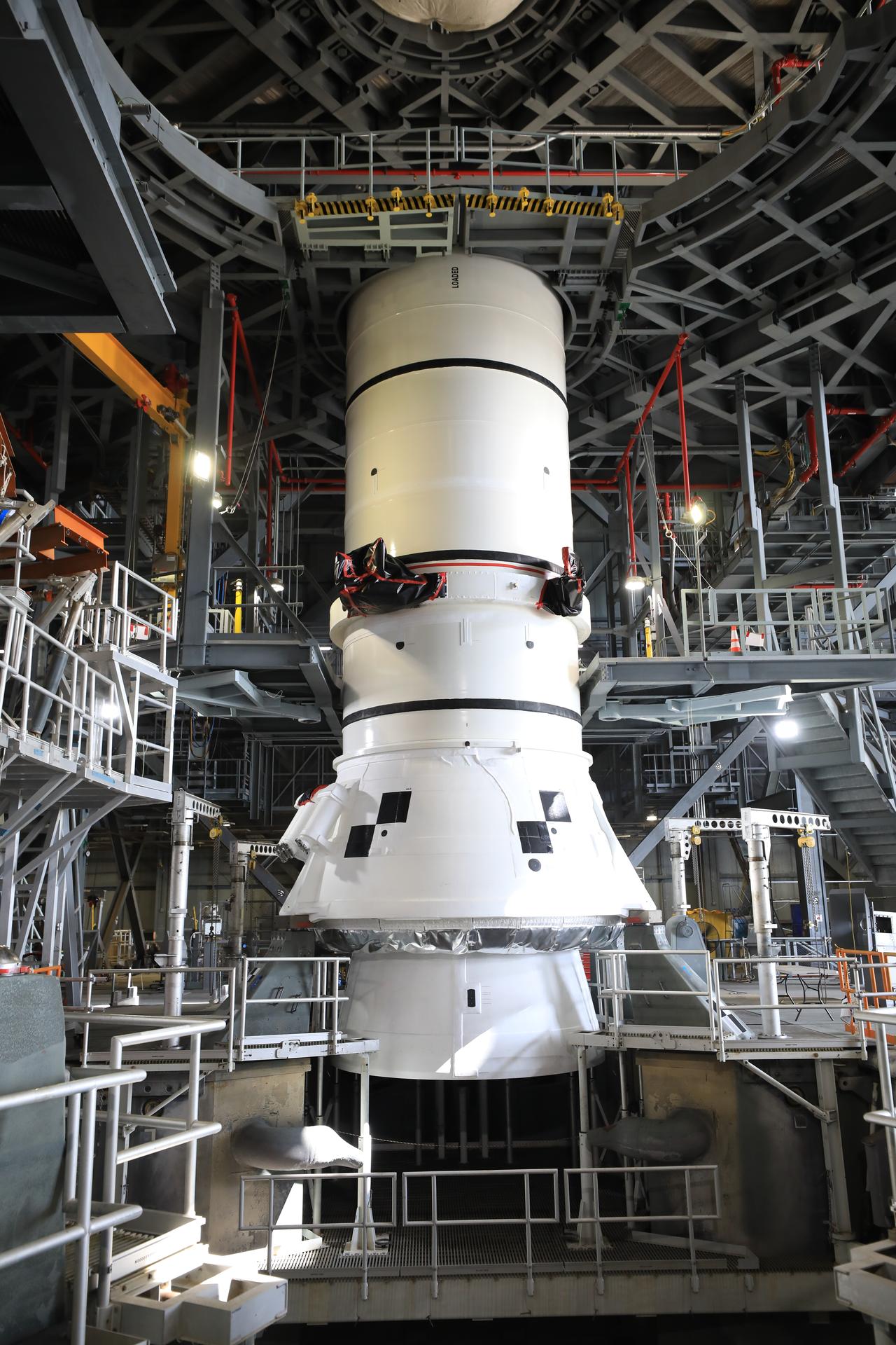 Teams with NASA’s Exploration Ground Systems lowered and secured the left-hand aft assembly solid rocket booster segment for NASA’s Artemis III SLS (Space Launch System) rocket to the mobile launcher at the agency’s Vehicle Assembly Building at NASA’s Kennedy Space Center in Florida on Thursday, July 9, 2026. The twin boosters, manufactured by Northrop Grumman in Utah, will provide more than 75 percent of the SLS rocket’s total thrust at launch. The Artemis III mission will launch crew in the Orion spacecraft on top of the SLS rocket to test rendezvous and docking capabilities between Orion and commercial spacecraft needed to land astronauts on the Moon.
