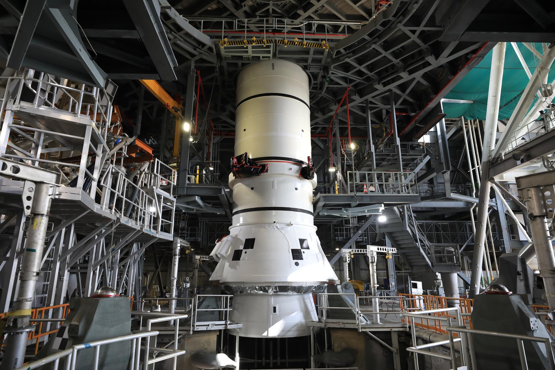 Teams with NASA’s Exploration Ground Systems lowered and secured the left-hand aft assembly solid rocket booster segment for NASA’s Artemis III SLS (Space Launch System) rocket to the mobile launcher at the agency’s Vehicle Assembly Building at NASA’s Kennedy Space Center in Florida on Thursday, July 9, 2026. The twin boosters, manufactured by Northrop Grumman in Utah, will provide more than 75 percent of the SLS rocket’s total thrust at launch. The Artemis III mission will launch crew in the Orion spacecraft on top of the SLS rocket to test rendezvous and docking capabilities between Orion and commercial spacecraft needed to land astronauts on the Moon.