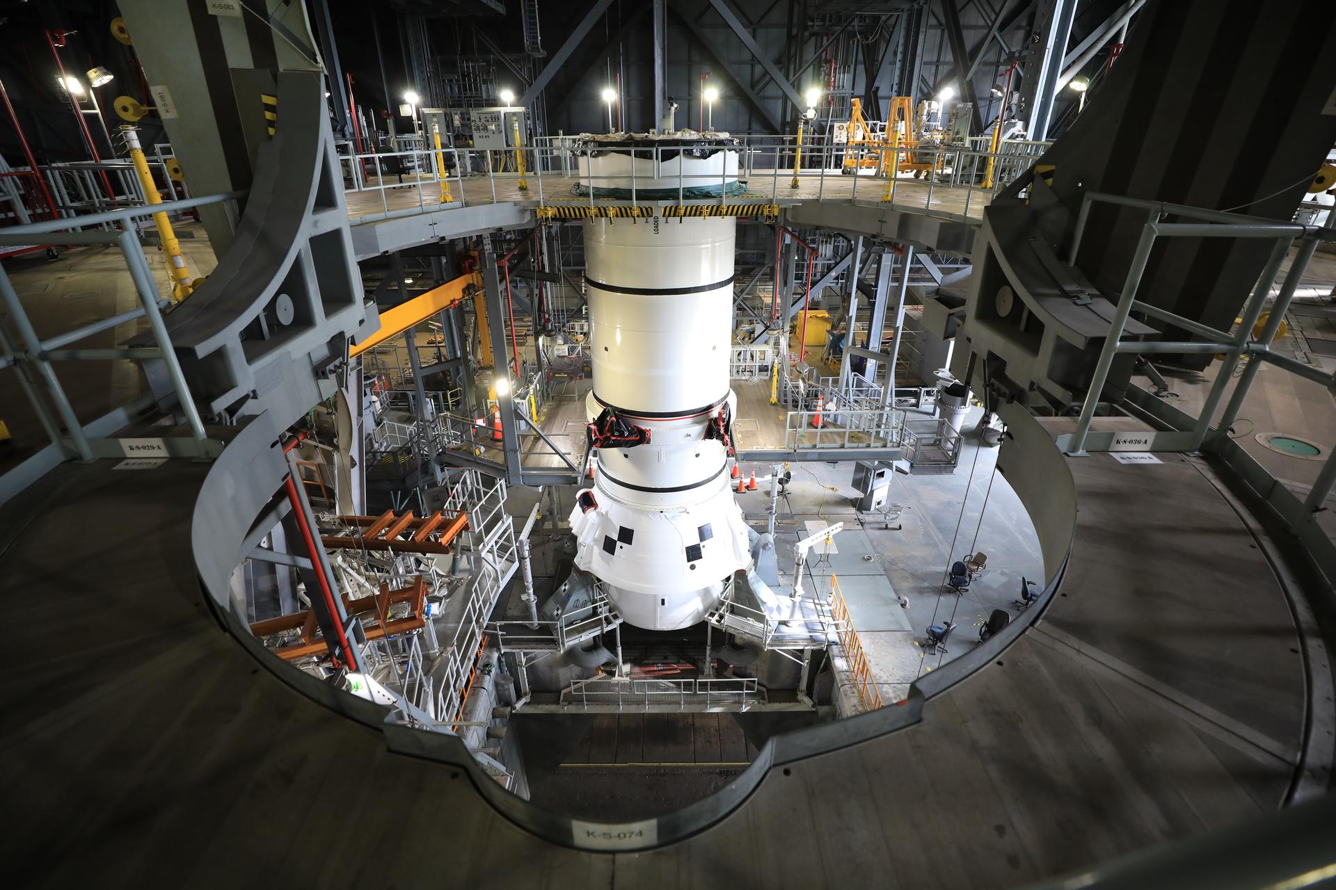 Teams with NASA’s Exploration Ground Systems lowered and secured the left-hand aft assembly solid rocket booster segment for NASA’s Artemis III SLS (Space Launch System) rocket to the mobile launcher at the agency’s Vehicle Assembly Building at NASA’s Kennedy Space Center in Florida on Thursday, July 9, 2026. The twin boosters, manufactured by Northrop Grumman in Utah, will provide more than 75 percent of the SLS rocket’s total thrust at launch. The Artemis III mission will launch crew in the Orion spacecraft on top of the SLS rocket to test rendezvous and docking capabilities between Orion and commercial spacecraft needed to land astronauts on the Moon.