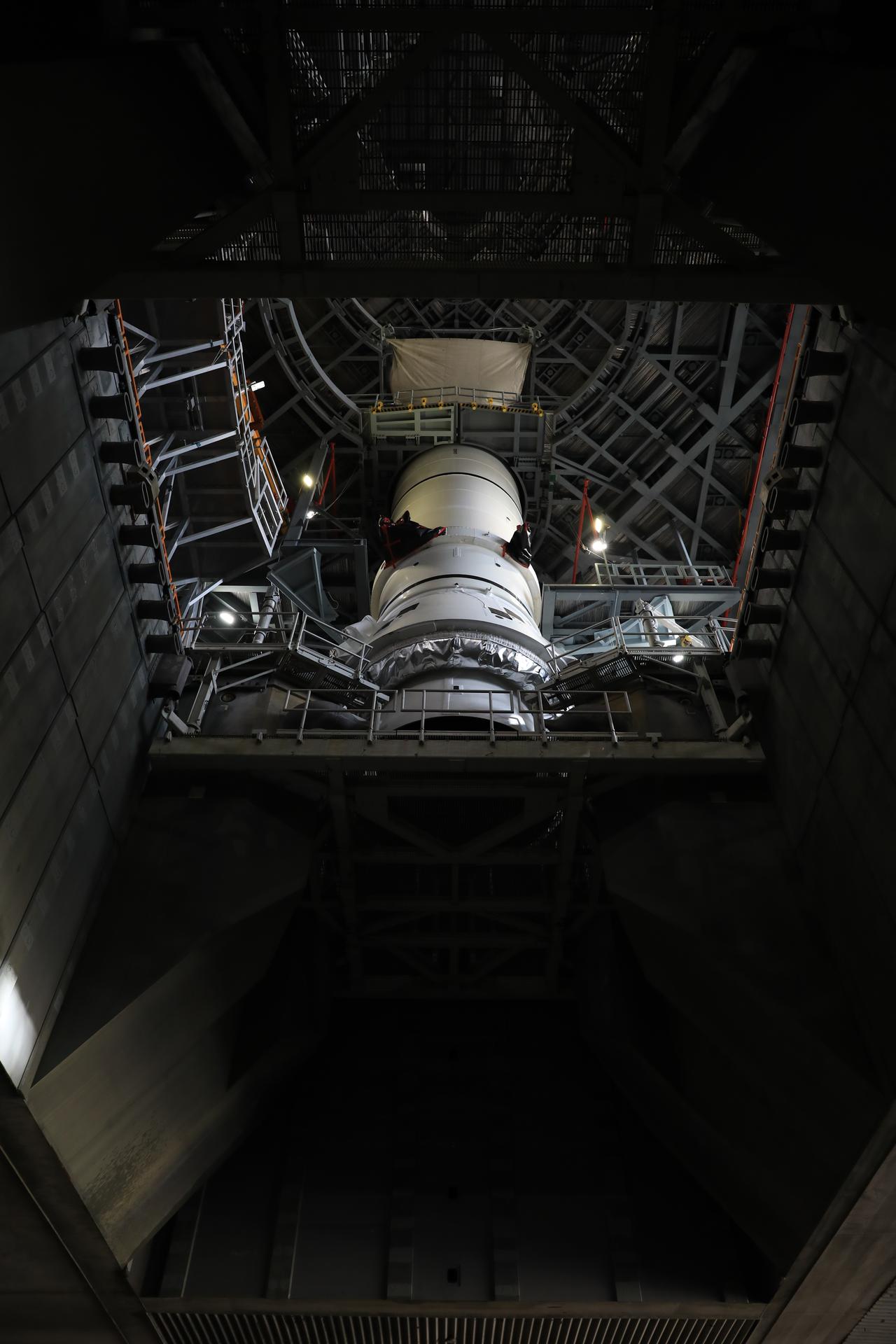 Teams with NASA’s Exploration Ground Systems lowered and secured the left-hand aft assembly solid rocket booster segment for NASA’s Artemis III SLS (Space Launch System) rocket to the mobile launcher at the agency’s Vehicle Assembly Building at NASA’s Kennedy Space Center in Florida on Thursday, July 9, 2026. The twin boosters, manufactured by Northrop Grumman in Utah, will provide more than 75 percent of the SLS rocket’s total thrust at launch. The Artemis III mission will launch crew in the Orion spacecraft on top of the SLS rocket to test rendezvous and docking capabilities between Orion and commercial spacecraft needed to land astronauts on the Moon.