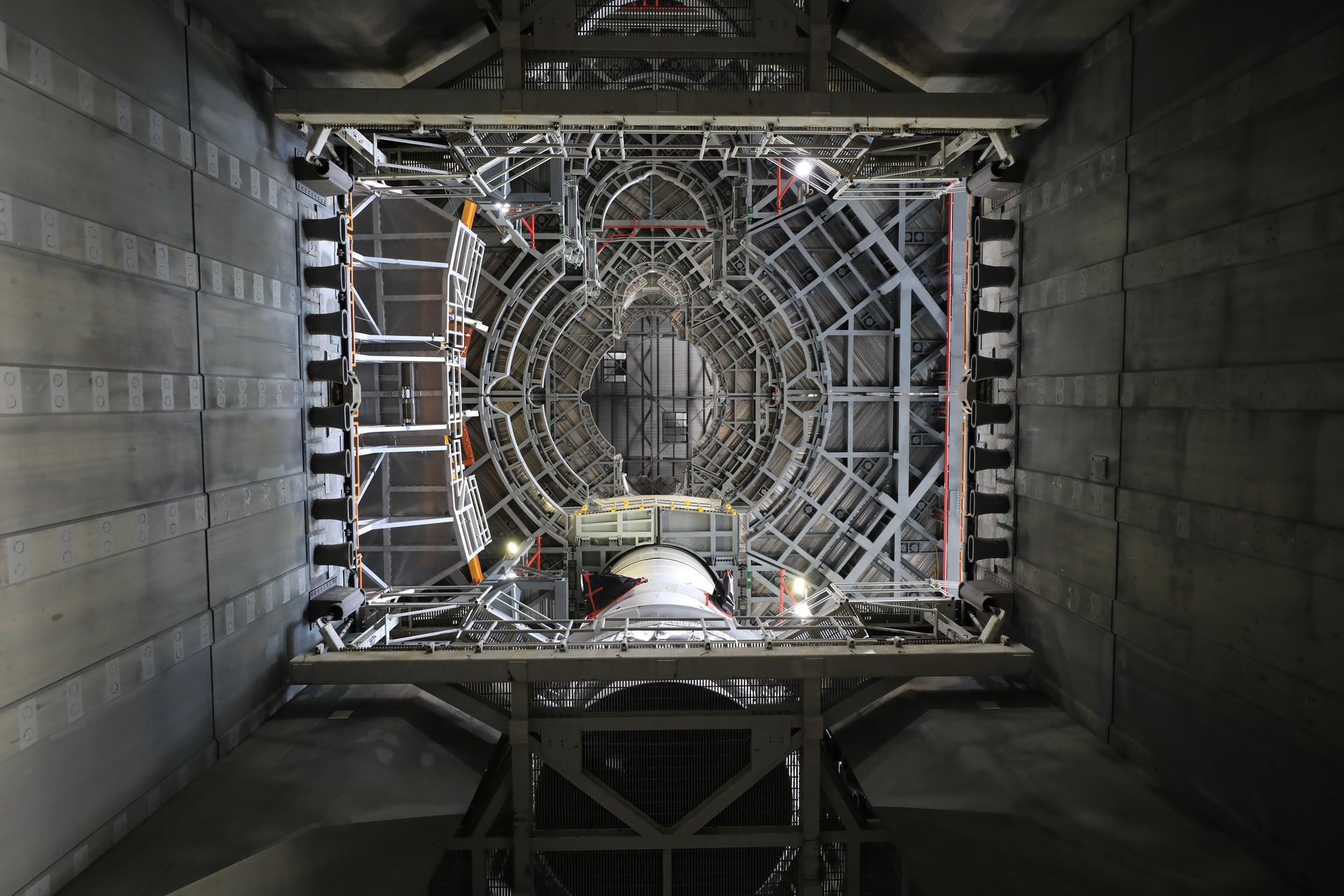 Teams with NASA’s Exploration Ground Systems lowered and secured the left-hand aft assembly solid rocket booster segment for NASA’s Artemis III SLS (Space Launch System) rocket to the mobile launcher at the agency’s Vehicle Assembly Building at NASA’s Kennedy Space Center in Florida on Thursday, July 9, 2026. The twin boosters, manufactured by Northrop Grumman in Utah, will provide more than 75 percent of the SLS rocket’s total thrust at launch. The Artemis III mission will launch crew in the Orion spacecraft on top of the SLS rocket to test rendezvous and docking capabilities between Orion and commercial spacecraft needed to land astronauts on the Moon.