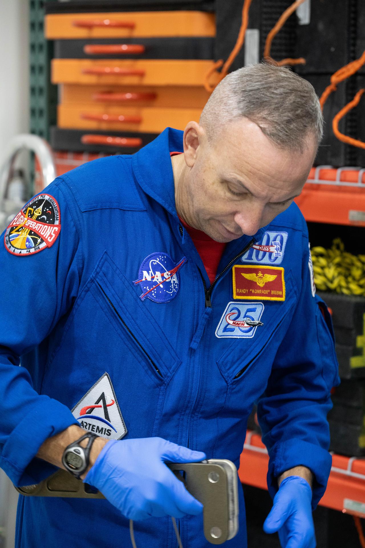 Artemis III crew members, NASA astronaut Randy Bresnick gets a close look at Orion spacecraft hardware inside the Multi-Payload Processing Facility at NASA’s Kennedy Space Center in Florida on Friday, July 10, 2026. Bresnick, along with fellow crewmate NASA astronaut Andre Douglas visited NASA Kennedy as part of preparations for their upcoming mission. Bresnick, Douglas, NASA astronaut Frank Rubio, and ESA (European Space Agency) astronaut Luca Parmitano will launch aboard Orion on the Artemis III mission to conduct critical rendezvous and docking tests with lunar lander systems in low Earth orbit, advancing the capabilities needed before astronauts return to the lunar surface on Artemis IV.